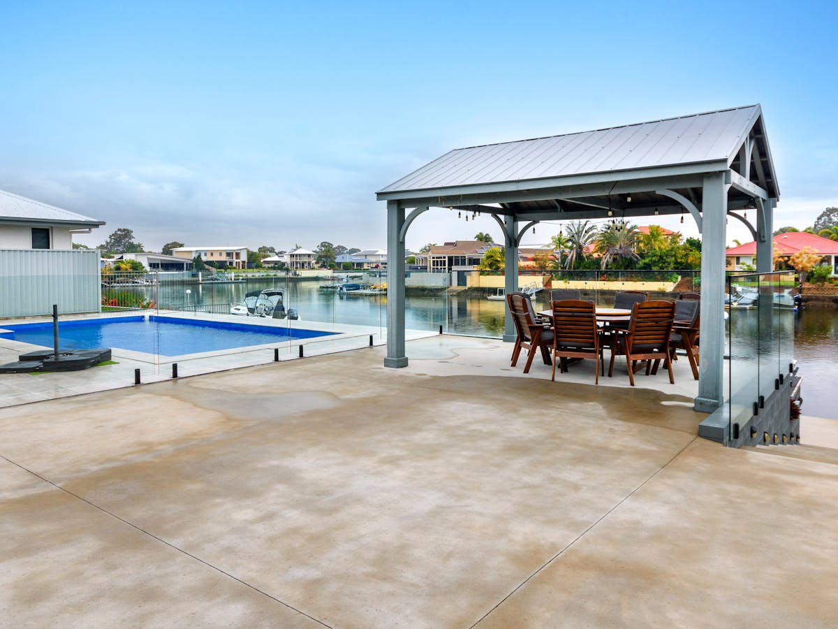 Outdoor gazebo and pool overlooking canal