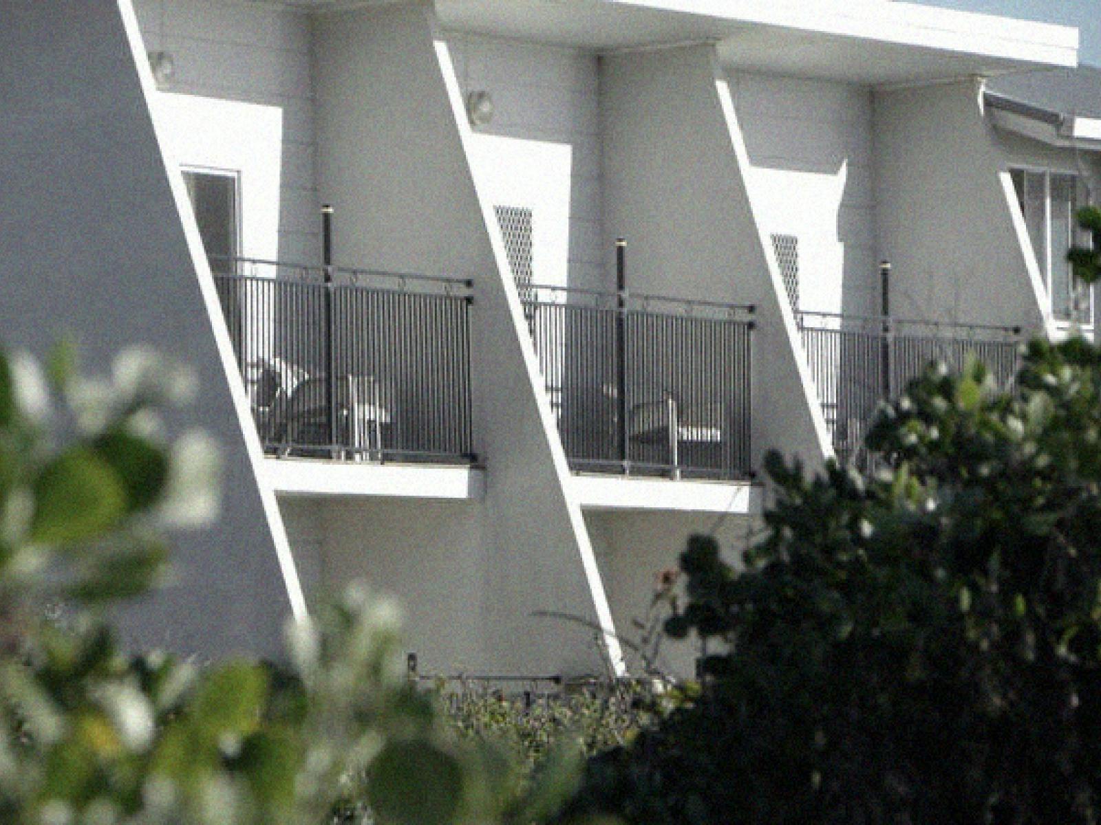 View of Saltwater Apartments building with foliage in foreground