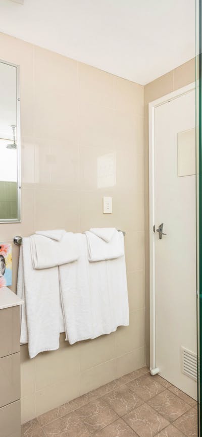Modern bathroom amenities with linen and towels provided at River Motel.