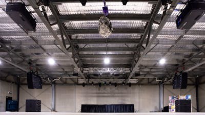 Large indoor space with house lights on and AV system in view