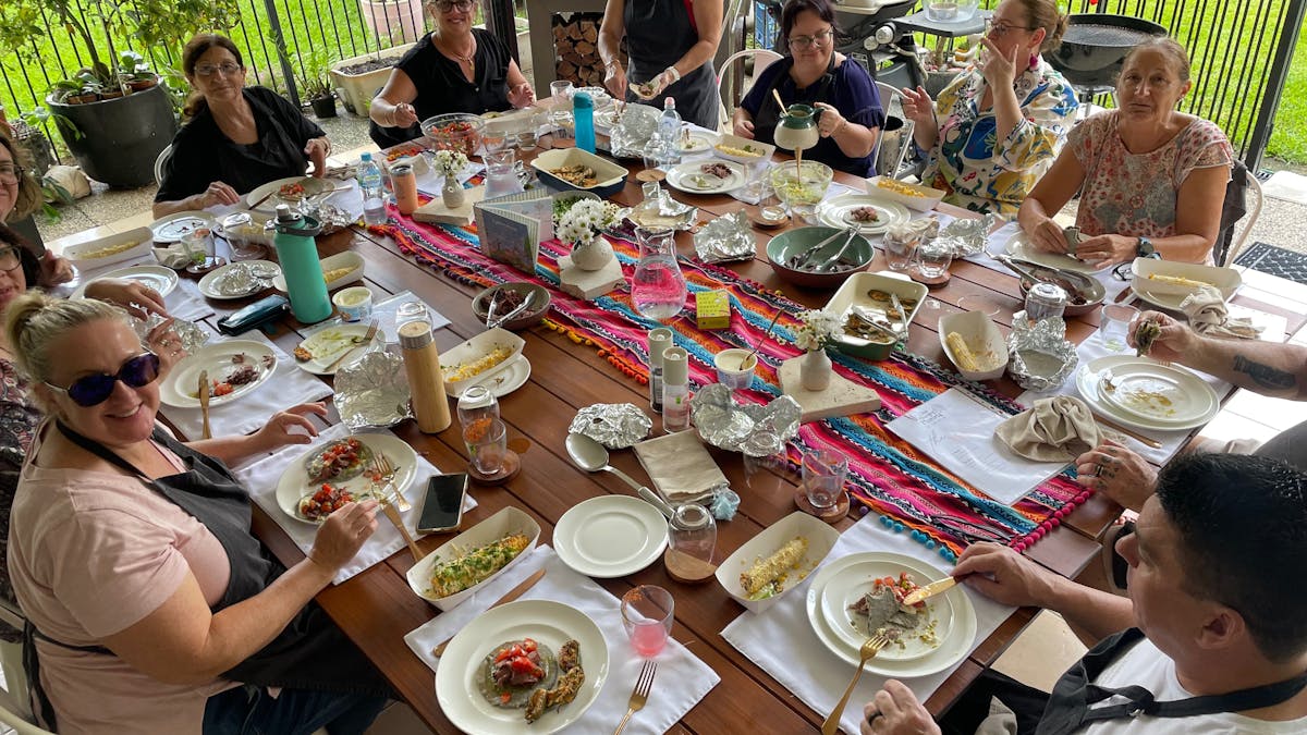 Participants sitting around a communal table at One Hungry Mumma in Finch Hatton