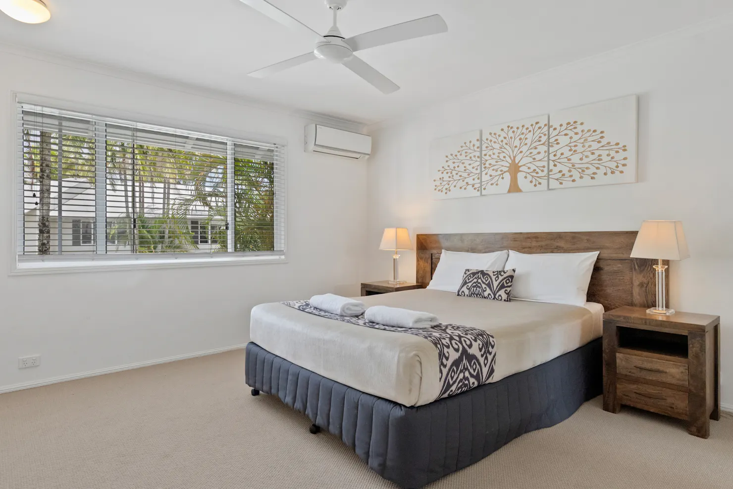 Bedroom with queen bed and bedside tables