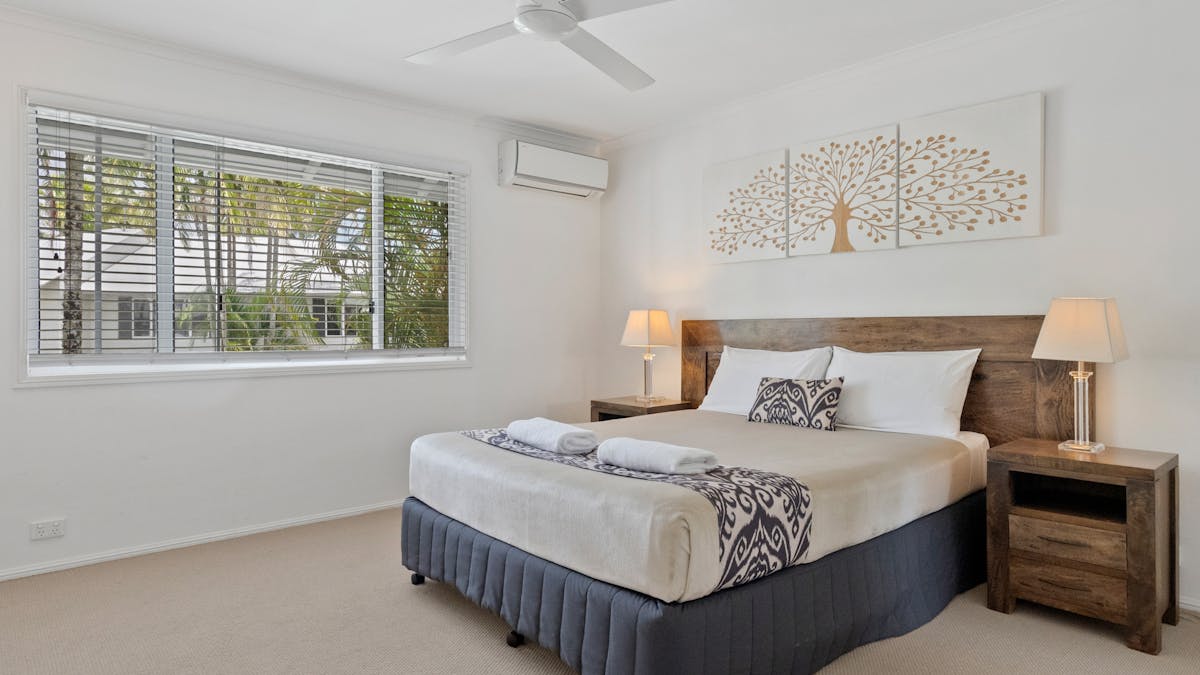 Bedroom with queen bed and bedside tables