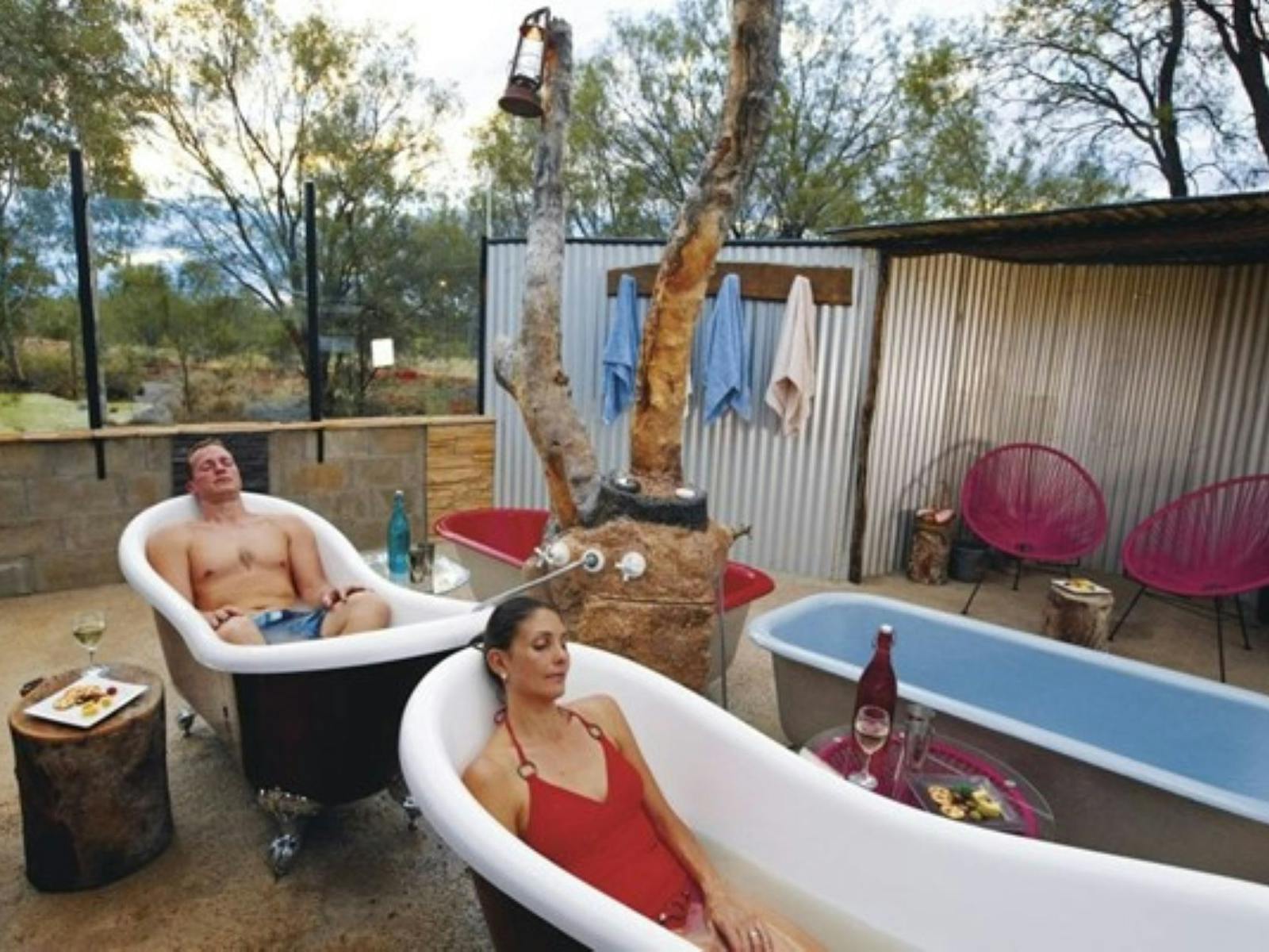 Man and Woman relax in a bath tub full of milky grey artesian mud water Man and Woman relax in a bath tub full of milky grey artesian mud water
