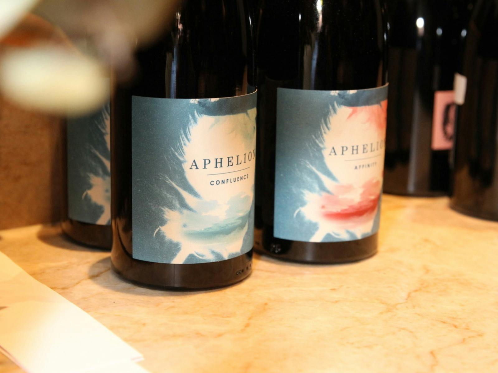 Two bottles of Aphelion wines, Confluence Grenache and Affinity Grenache-Mourvedre on a table