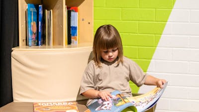 A child reading a book at Questacon