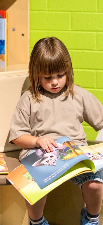 A child reading a book at Questacon