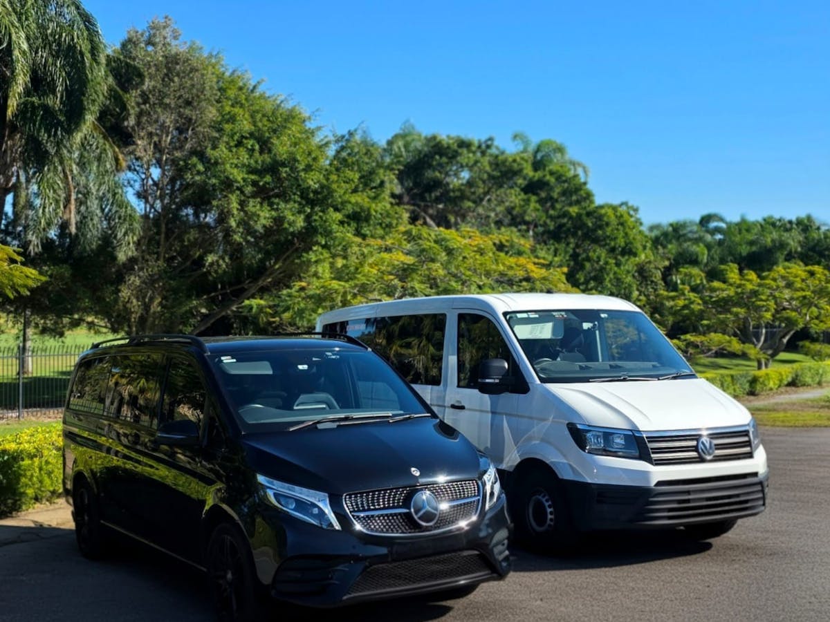 Black Mercedes-Benz van and white Volkswagen van from GEC Transfers parked