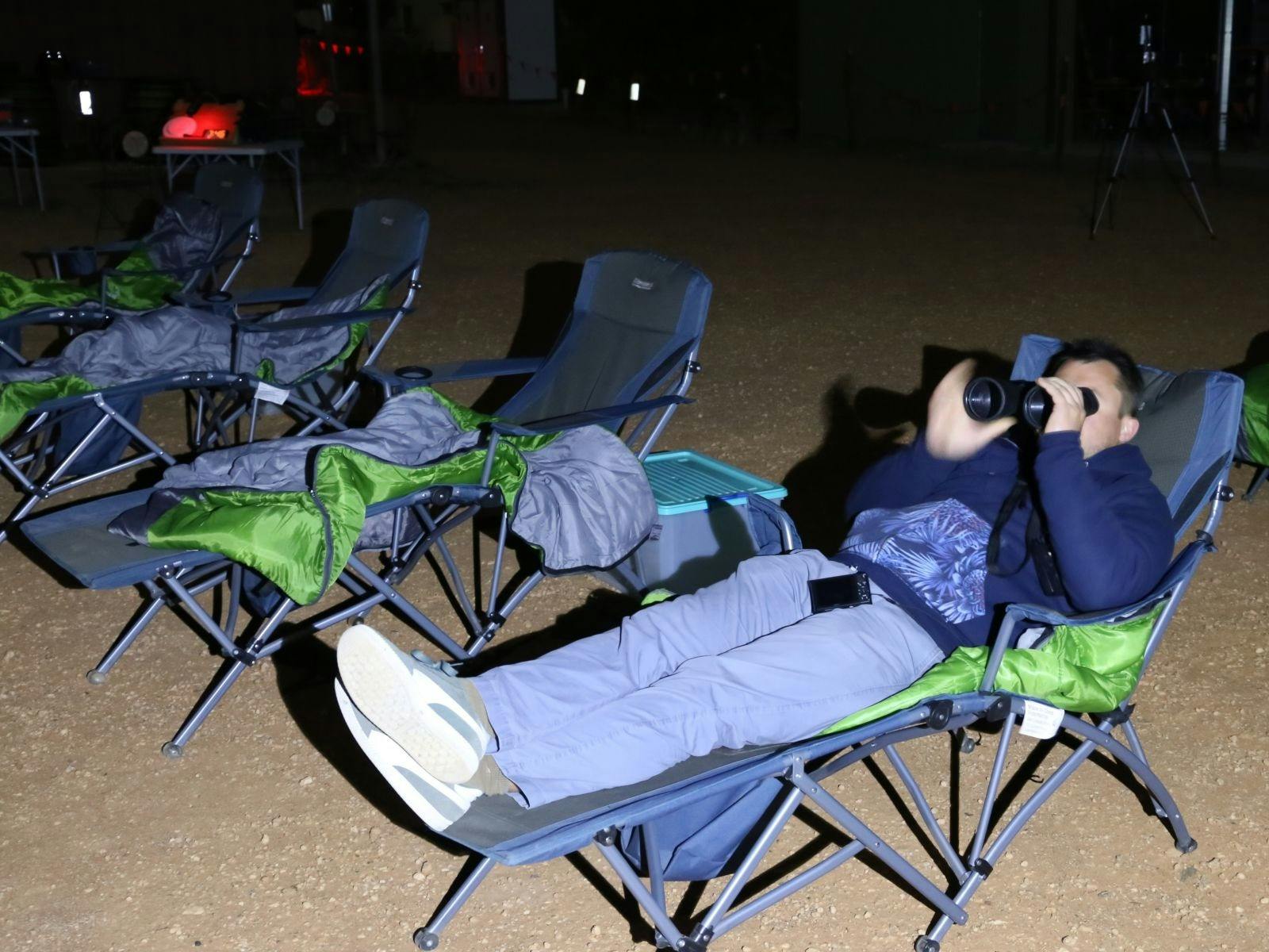 Man in reclined chair with sleeping bag