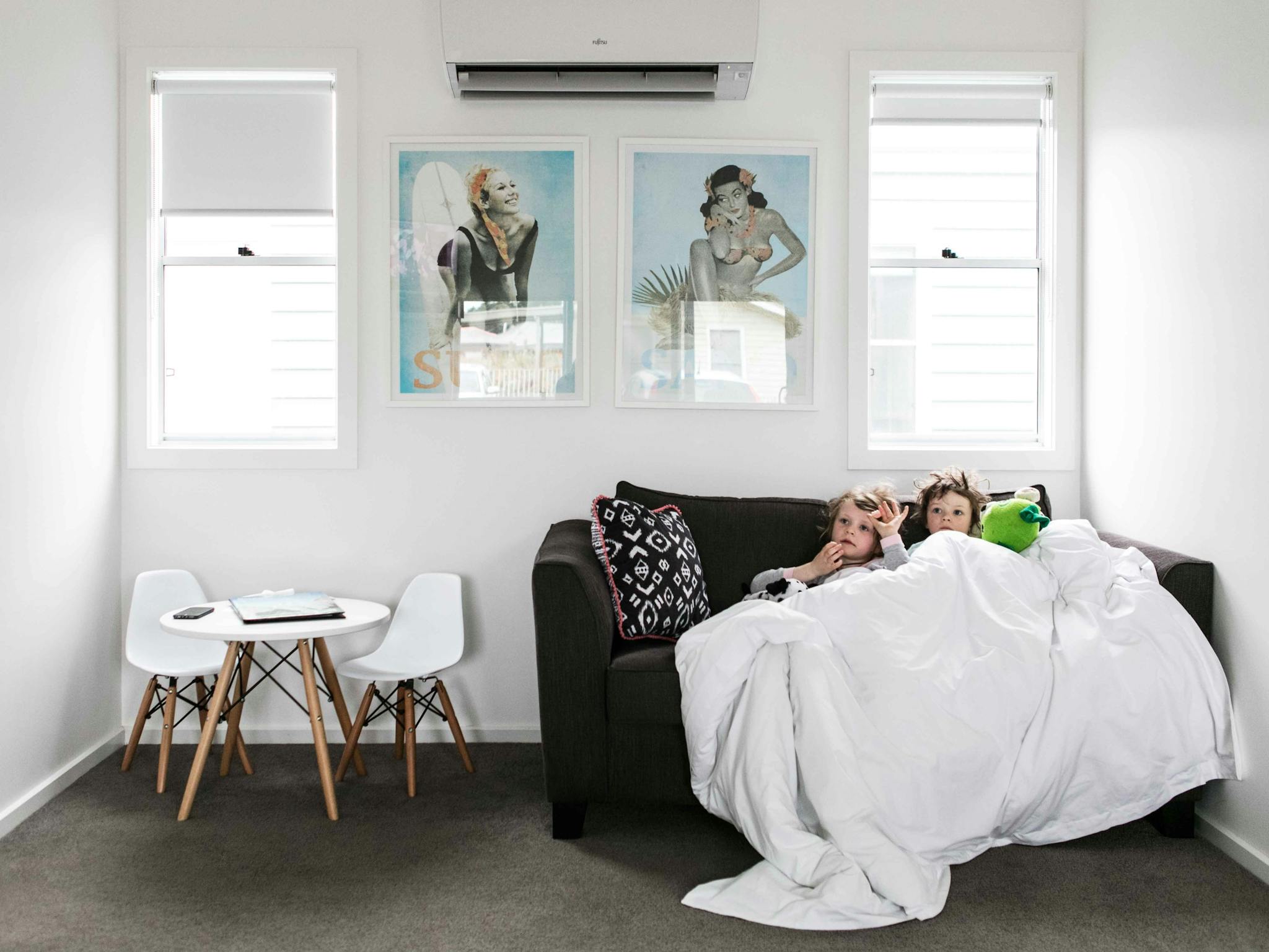 Kids comfy on the couch of the two bedroom unit