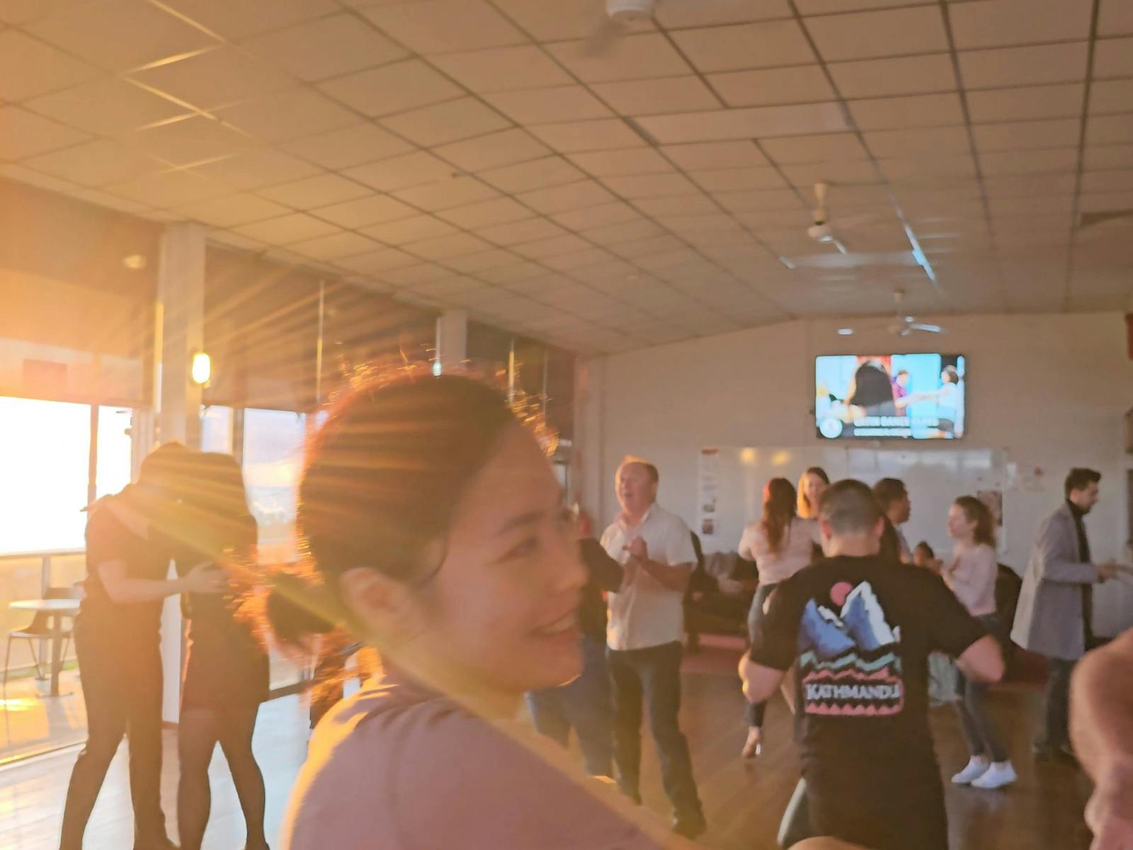 Dancers enjoying latin music with a beautiful sunset in the back drop