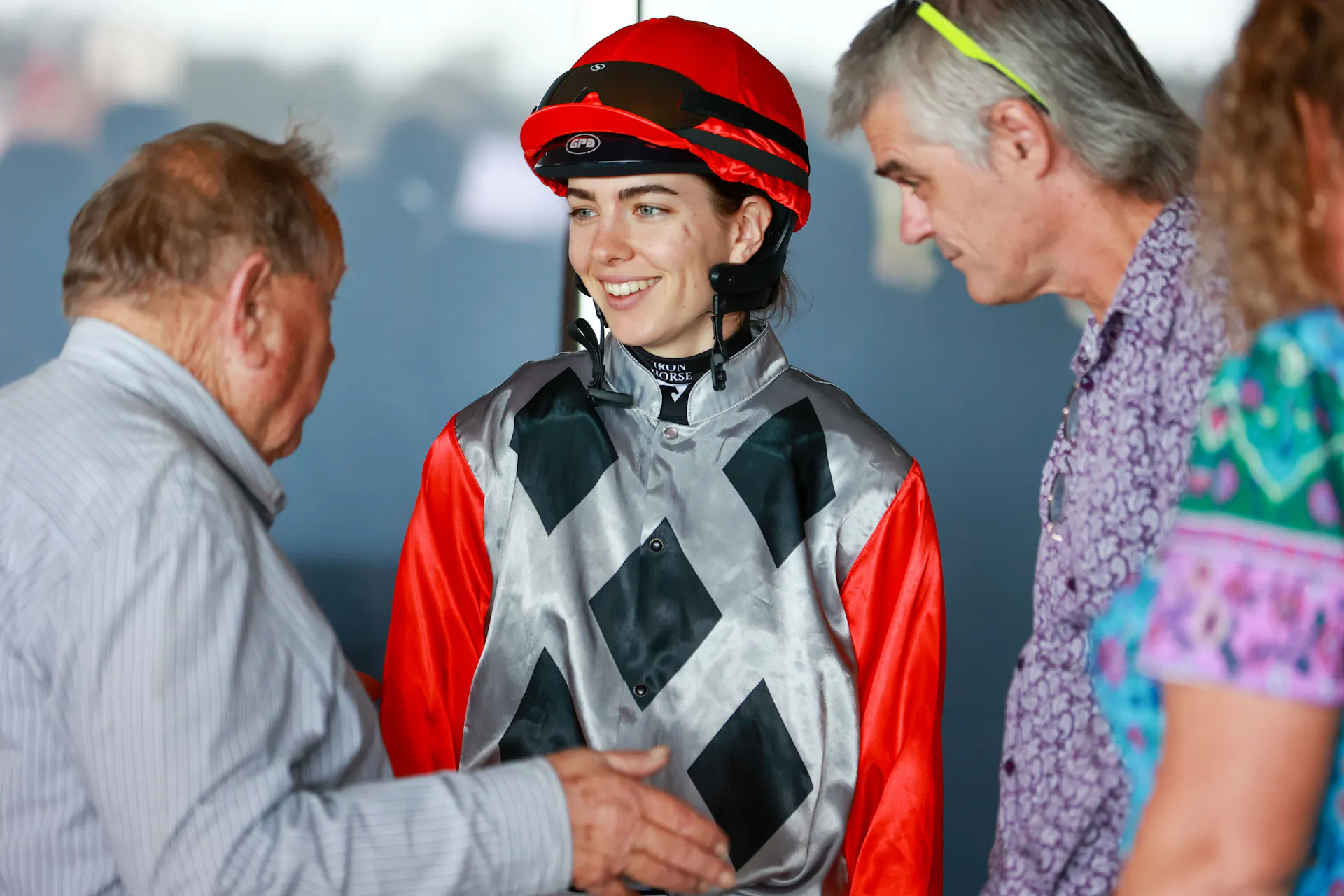 Jockey smiling in mounting yard