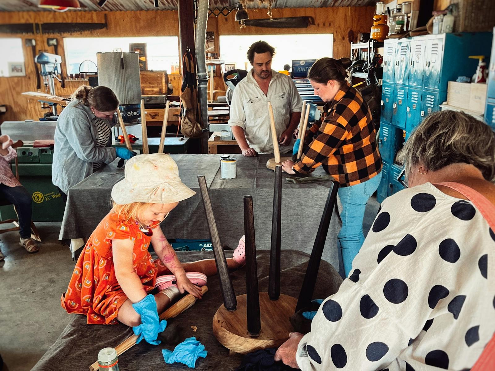 Three participants oil four legged stools