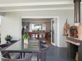 Cook wood-fired pizza in minutes, watch TV, play pool or board games overlooking Rivoli Bay