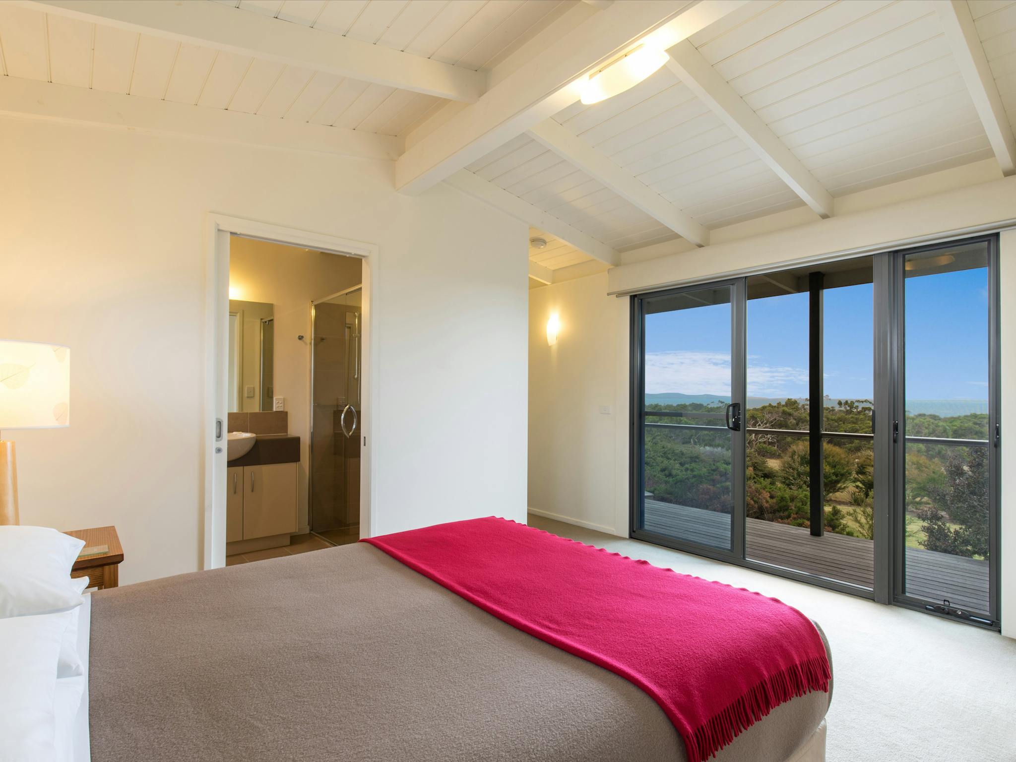 Queen bed with view through window
