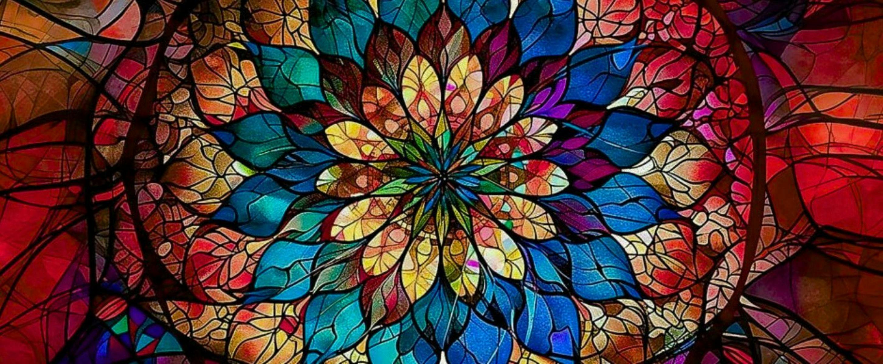 Stained glass image in the shape of a flower.