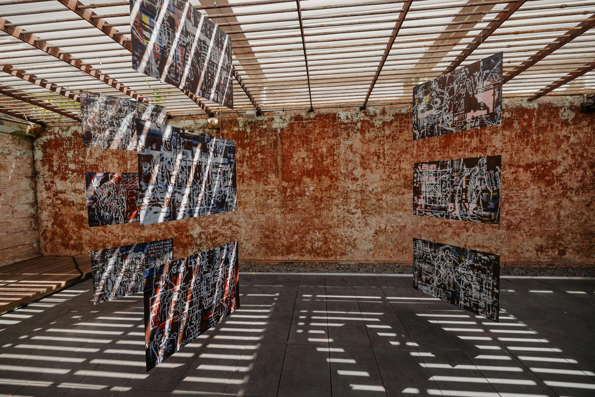 Paintings hanging from ceiling in a semi outdoor exercise yard of The Lock-Up