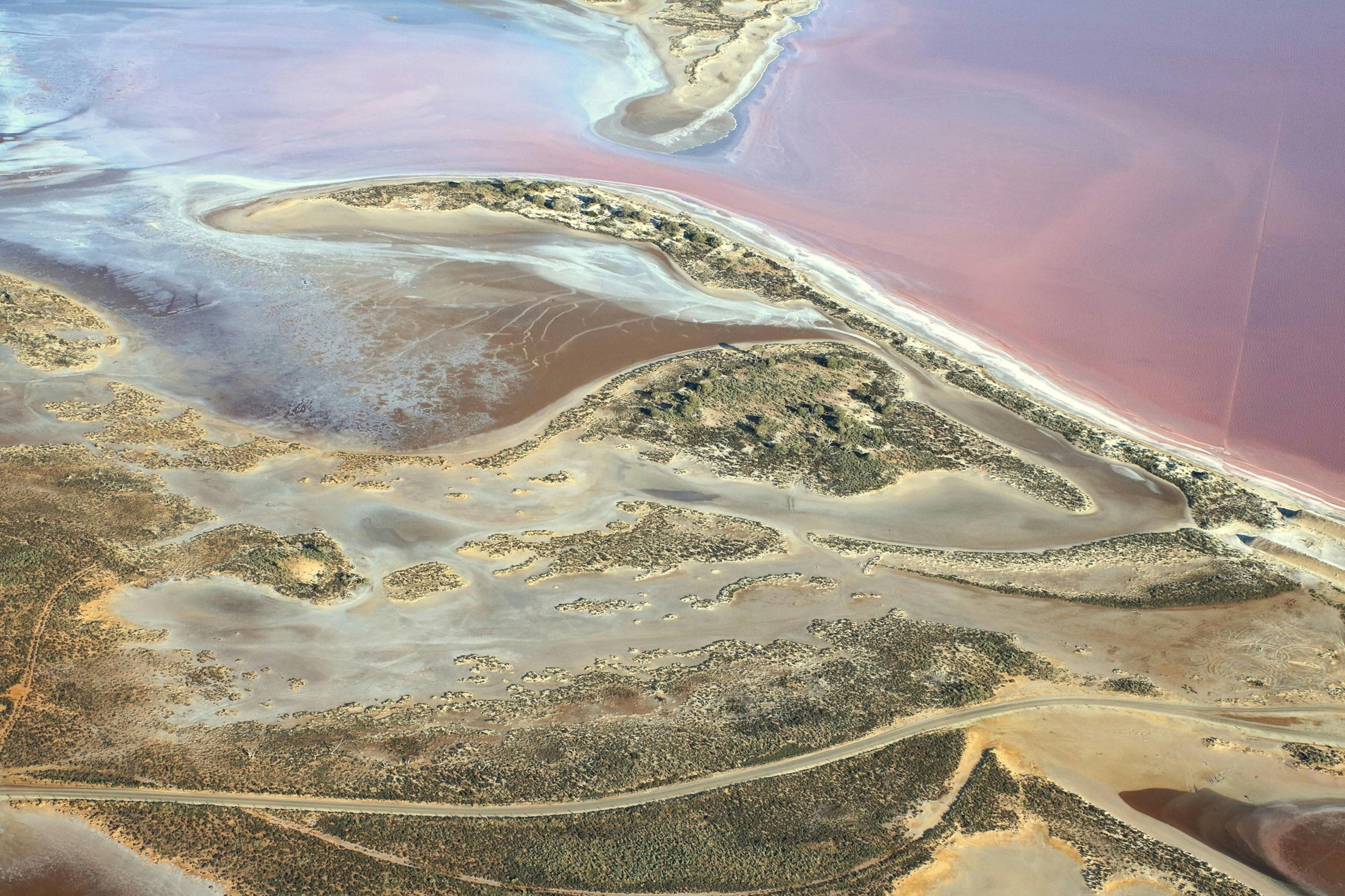 Aerial image of pink water, islands and vegetation at Lake Tyrrell.