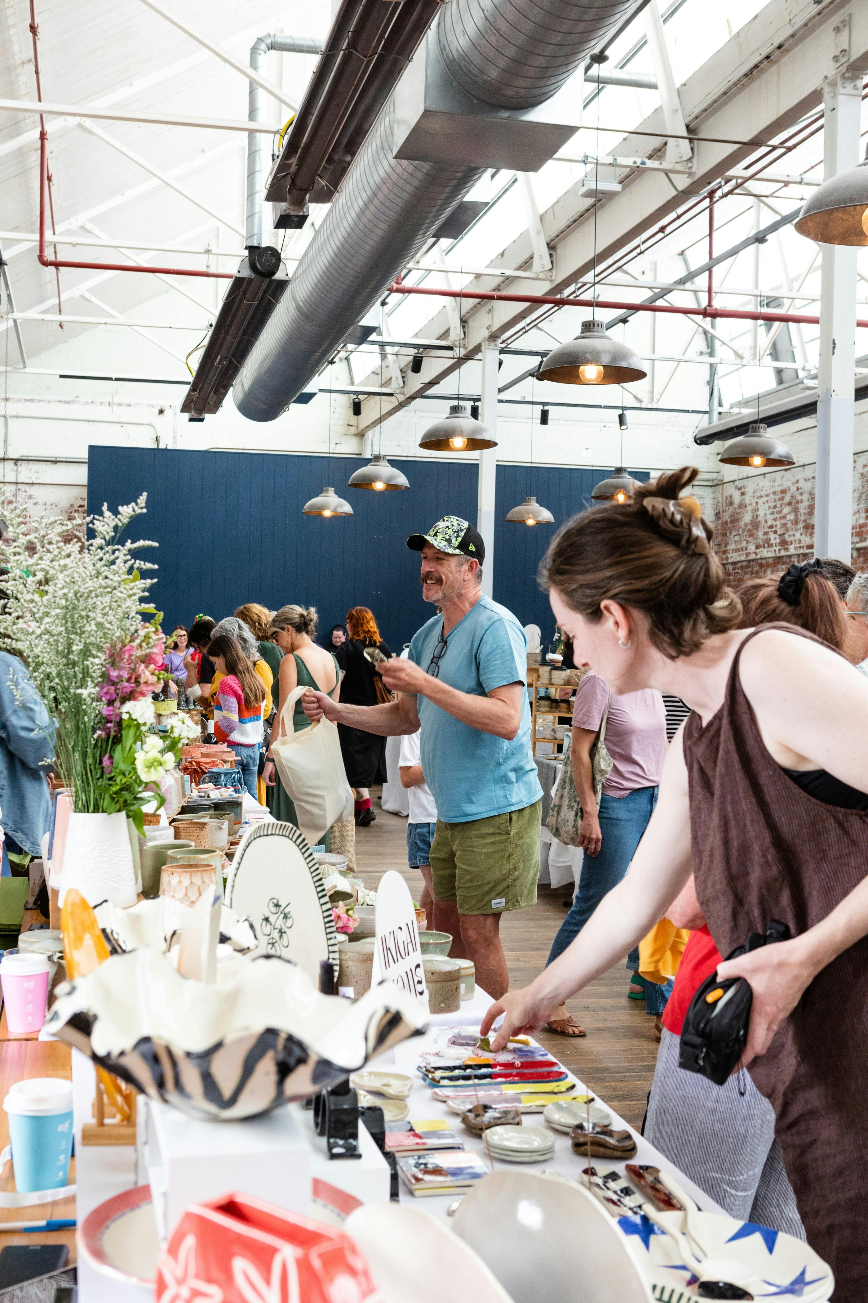 Crowds browsing handmade ceramics at the Geelong Ceramics Market inside Furphy Hall