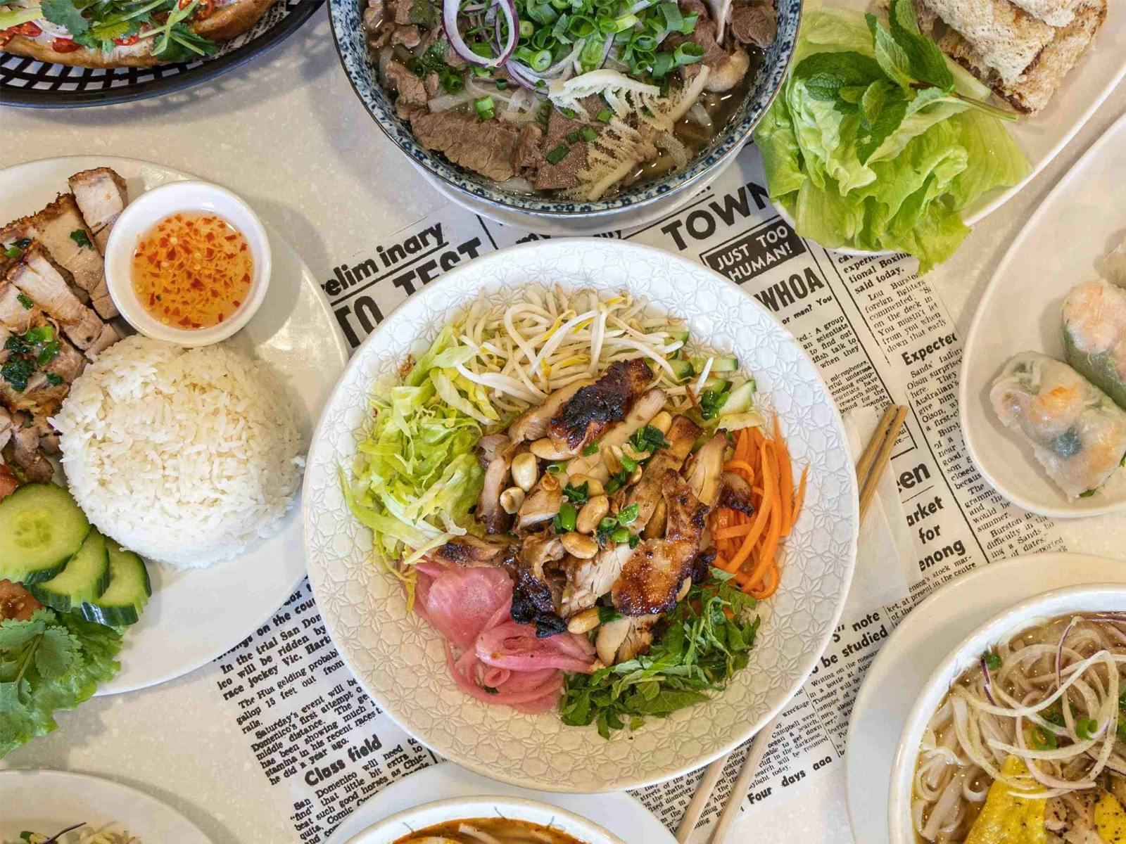 a bowl of vermicelli noodles with salad and bbq chicken