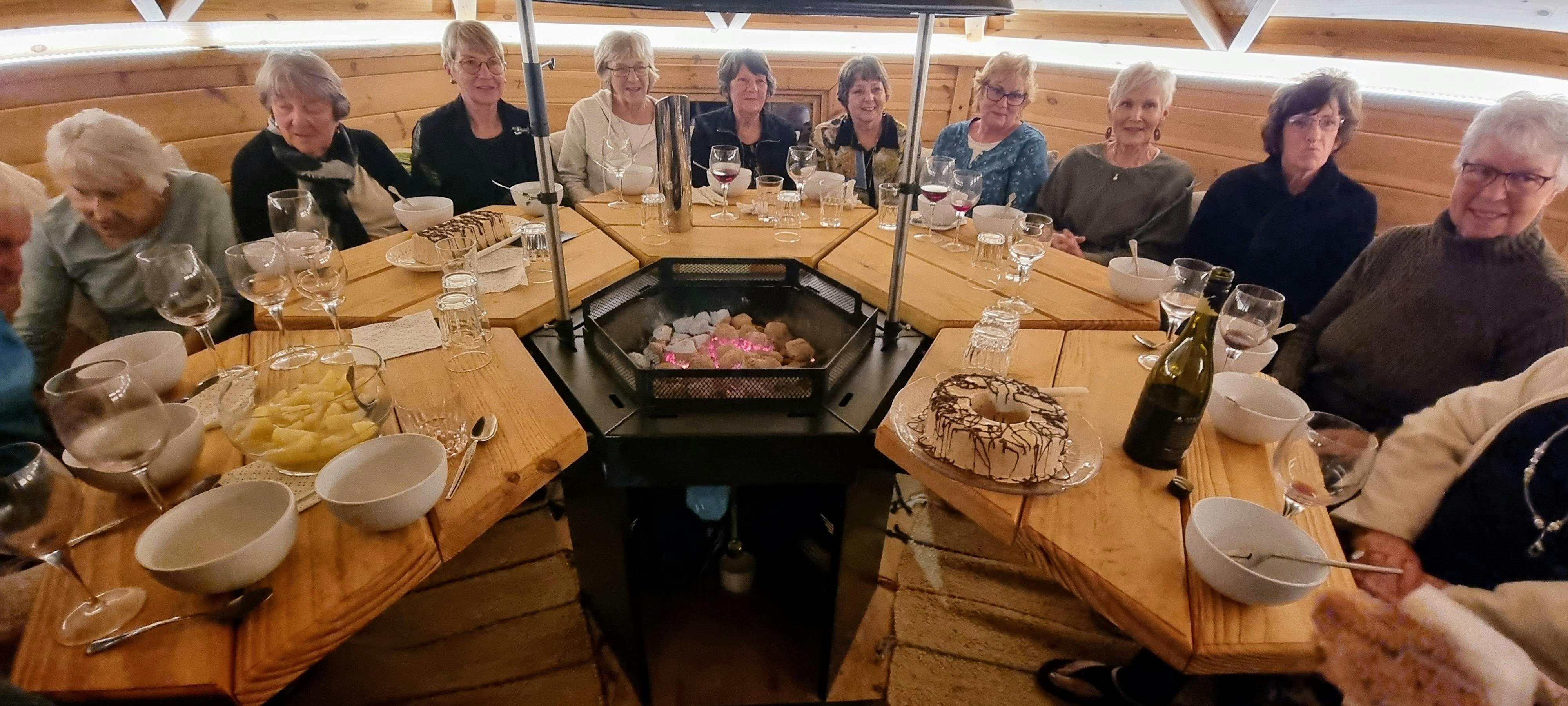 A group of people having dinner in a unique setting