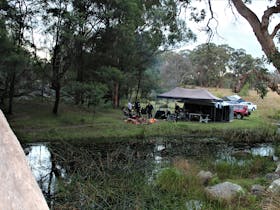 A campertrailer beside the water at one of our sites.