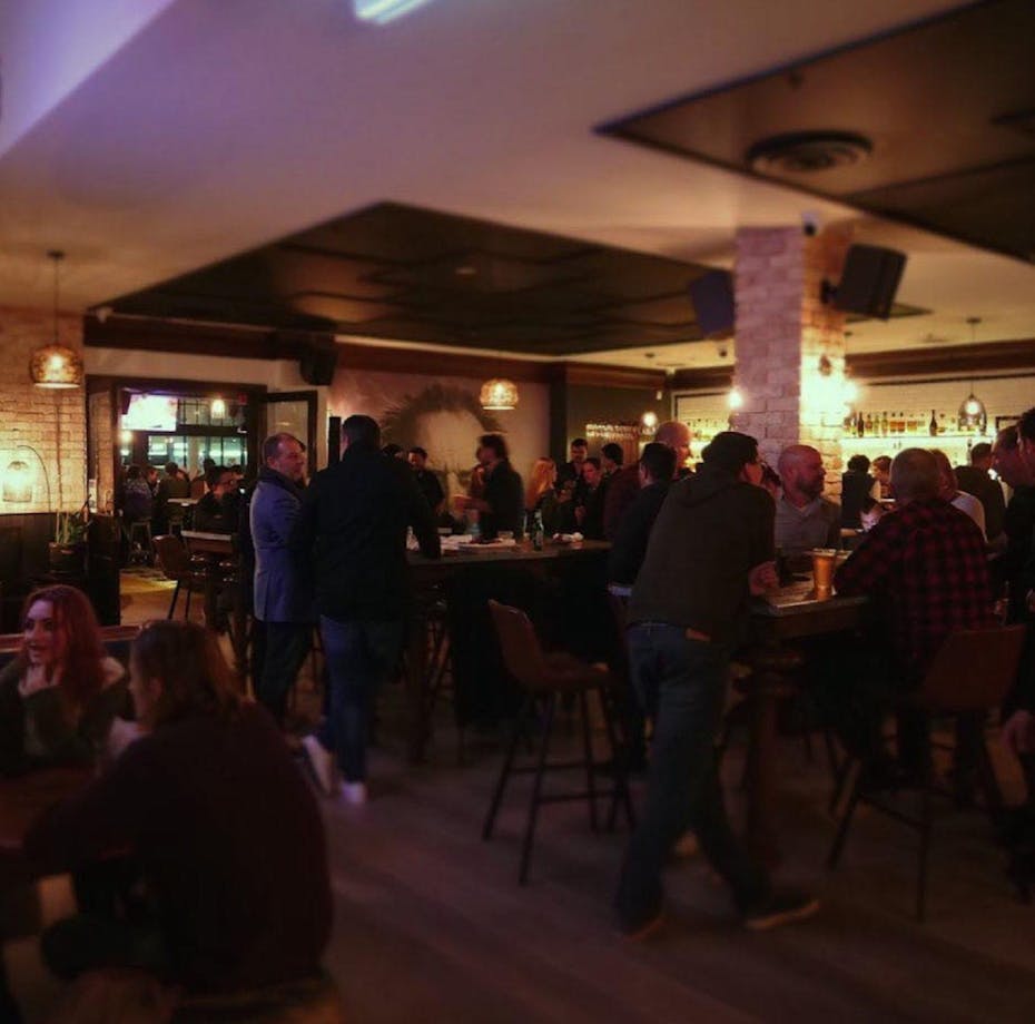 People standing at the bar talking
