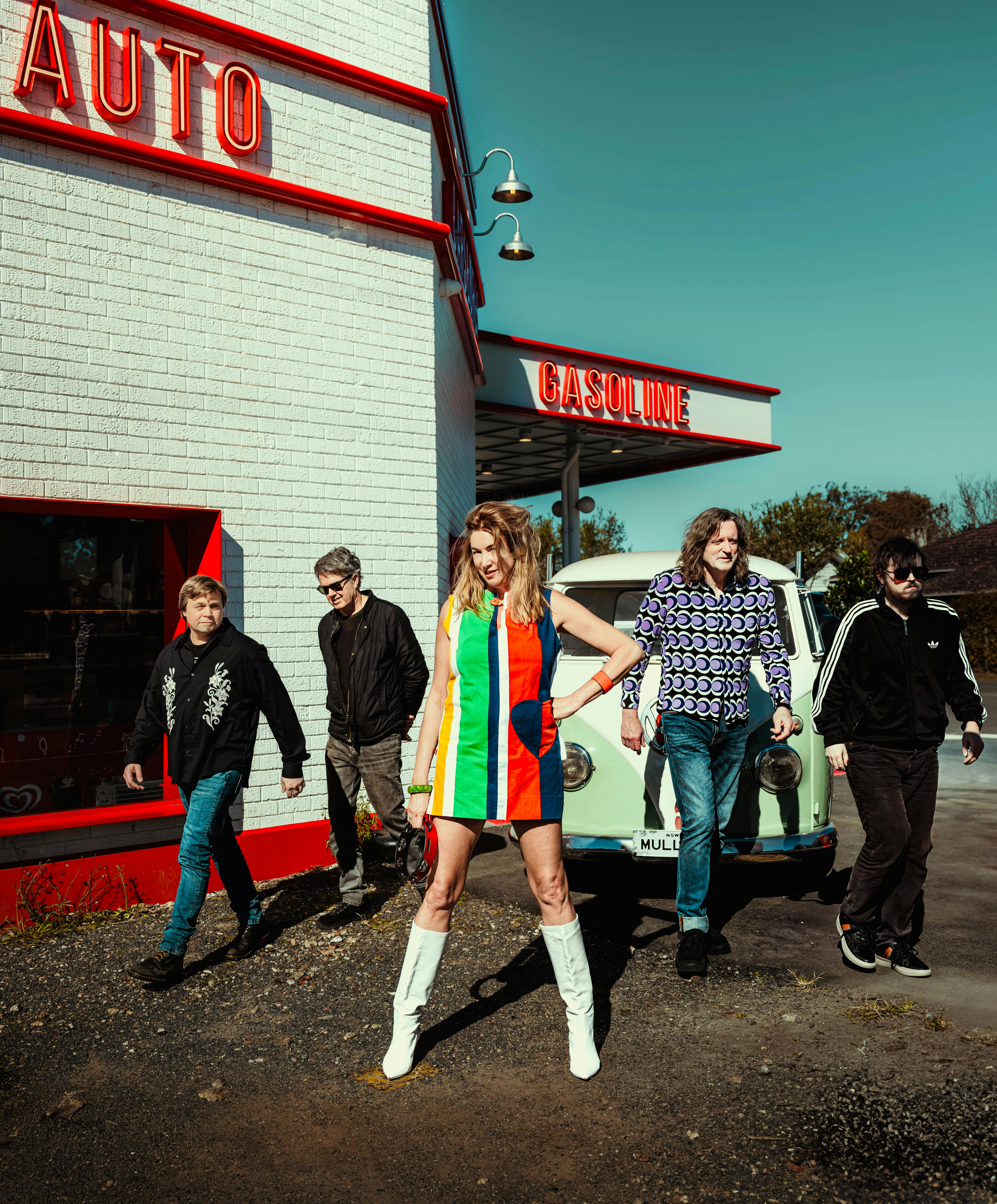 The Soul Movers standing in front of a white building. They are walking away from the building.