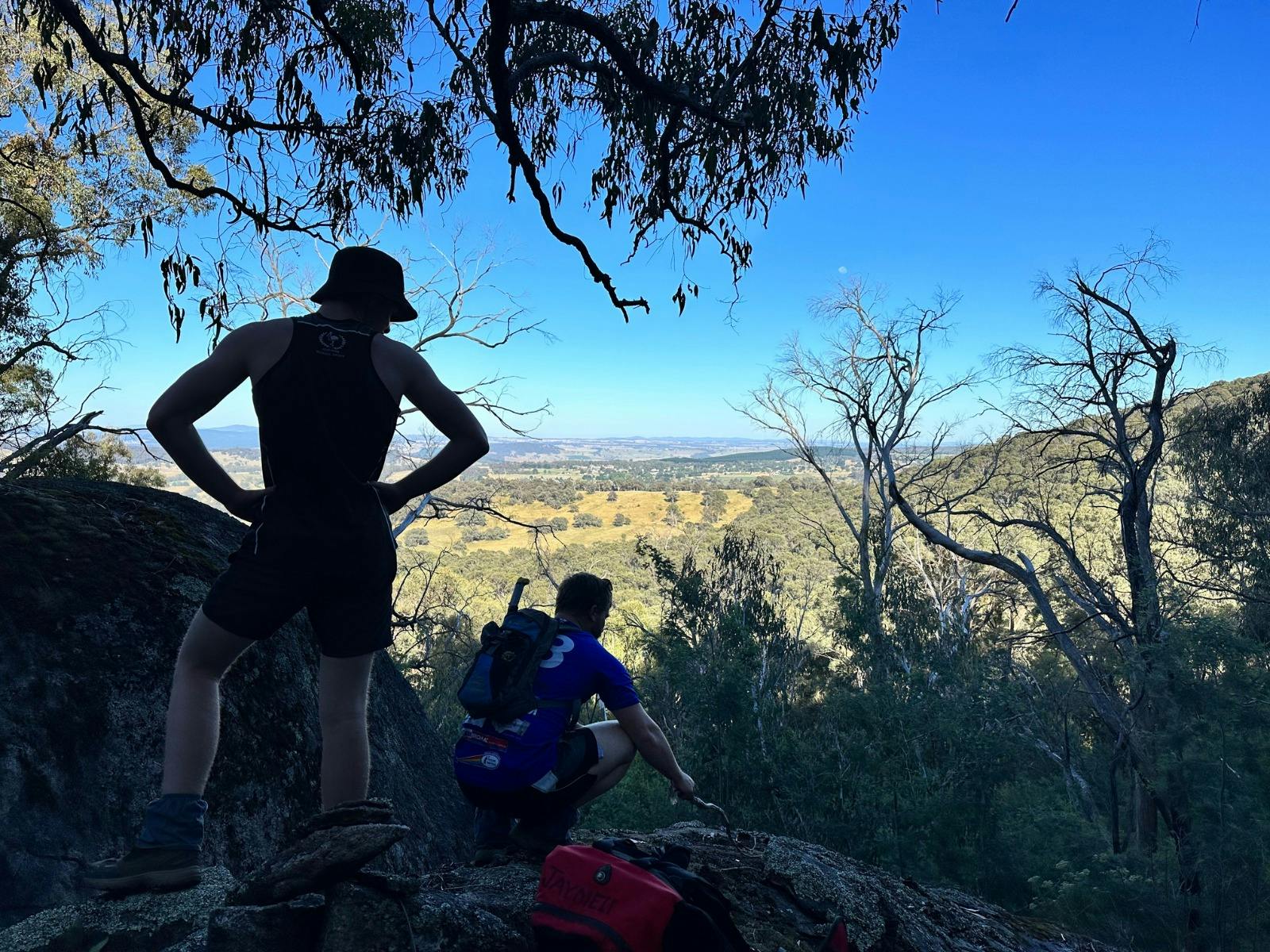 Walkers on the hiking track on Mt Tumbarumba enjoy a break and take in the views over the range