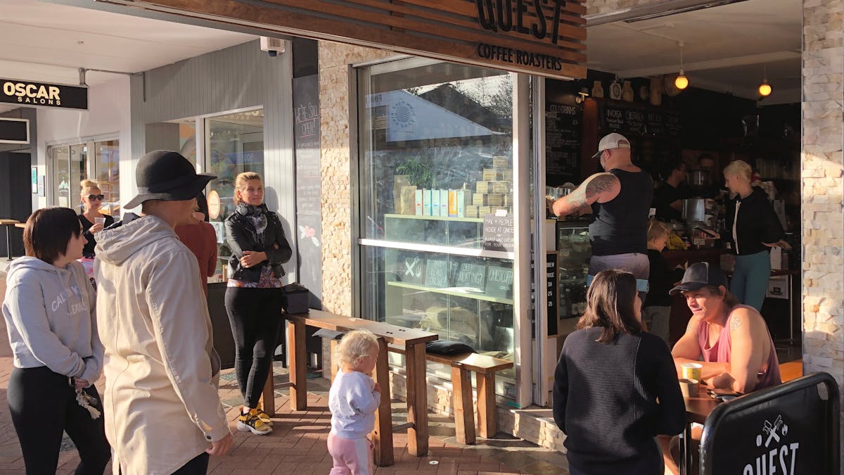 People awaiting drink and food orders at Quest Burleigh Cafe
