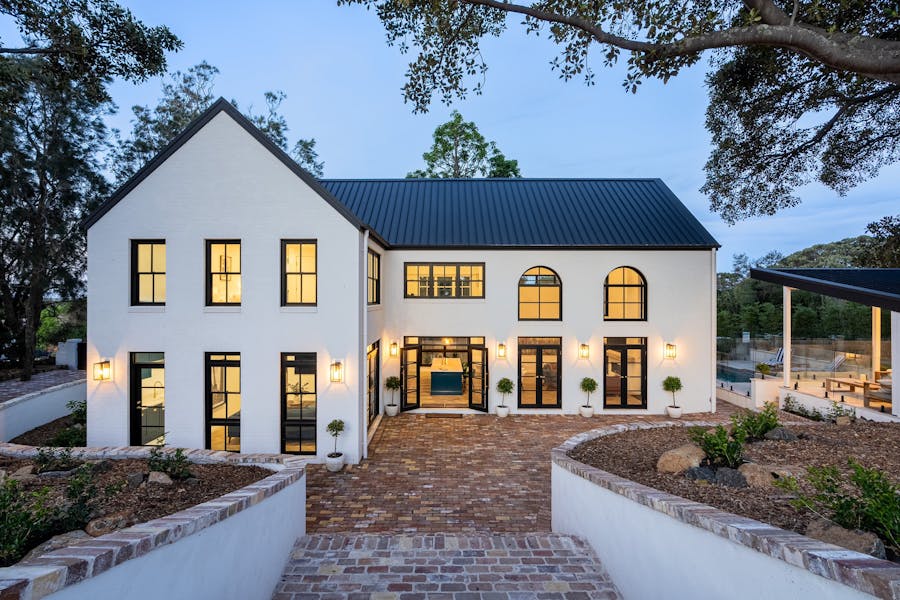 A facade shot of a luxury BnB at twilight