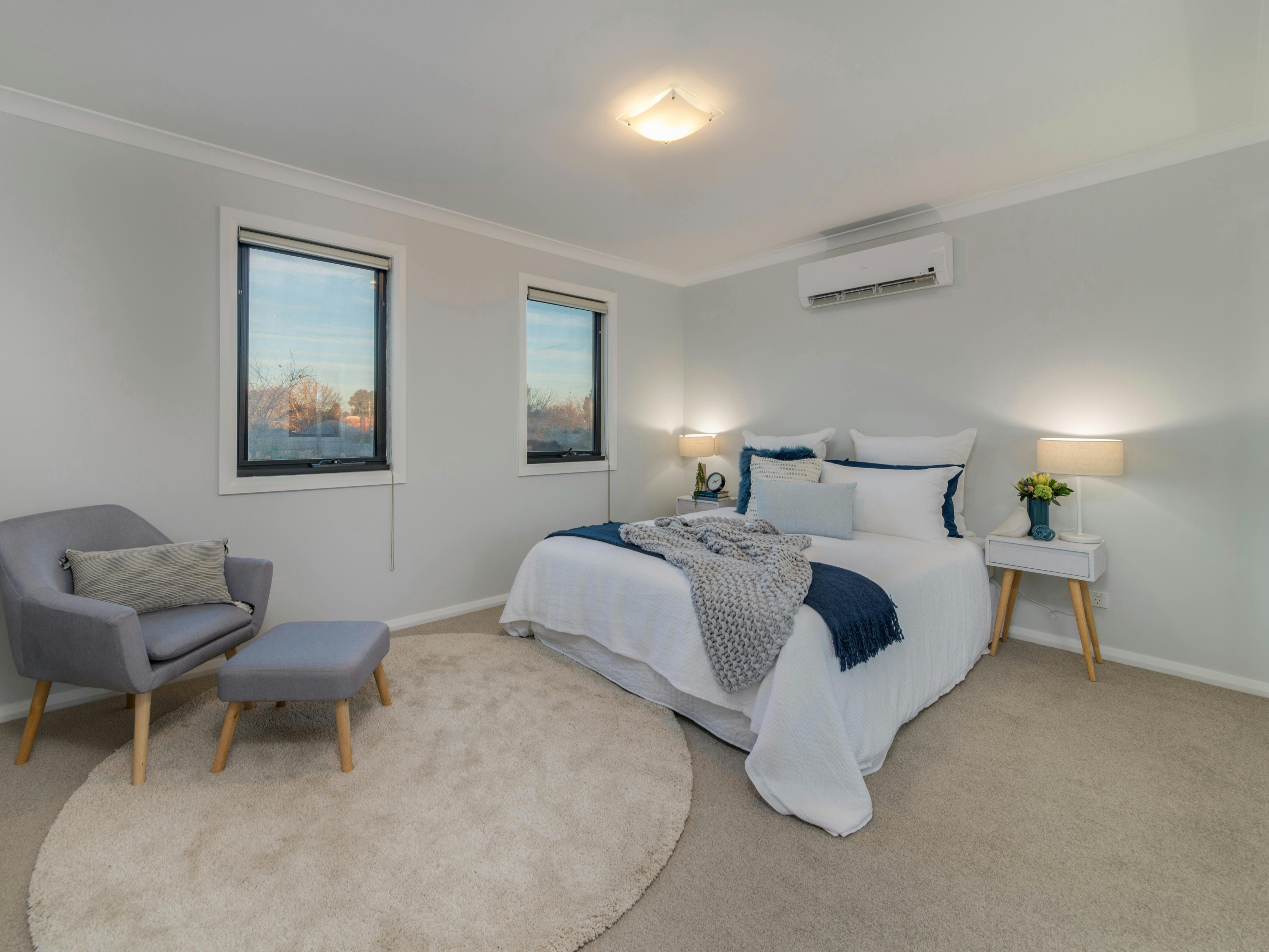 Room with bed, split system and chair