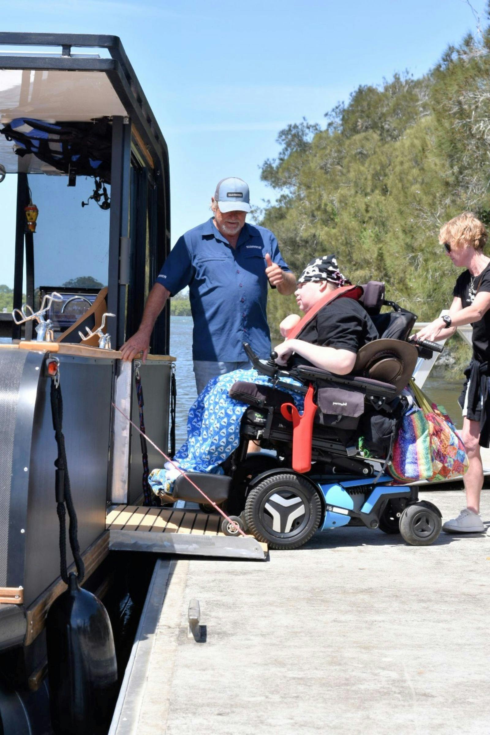 wheelchair going up ramp onto boat