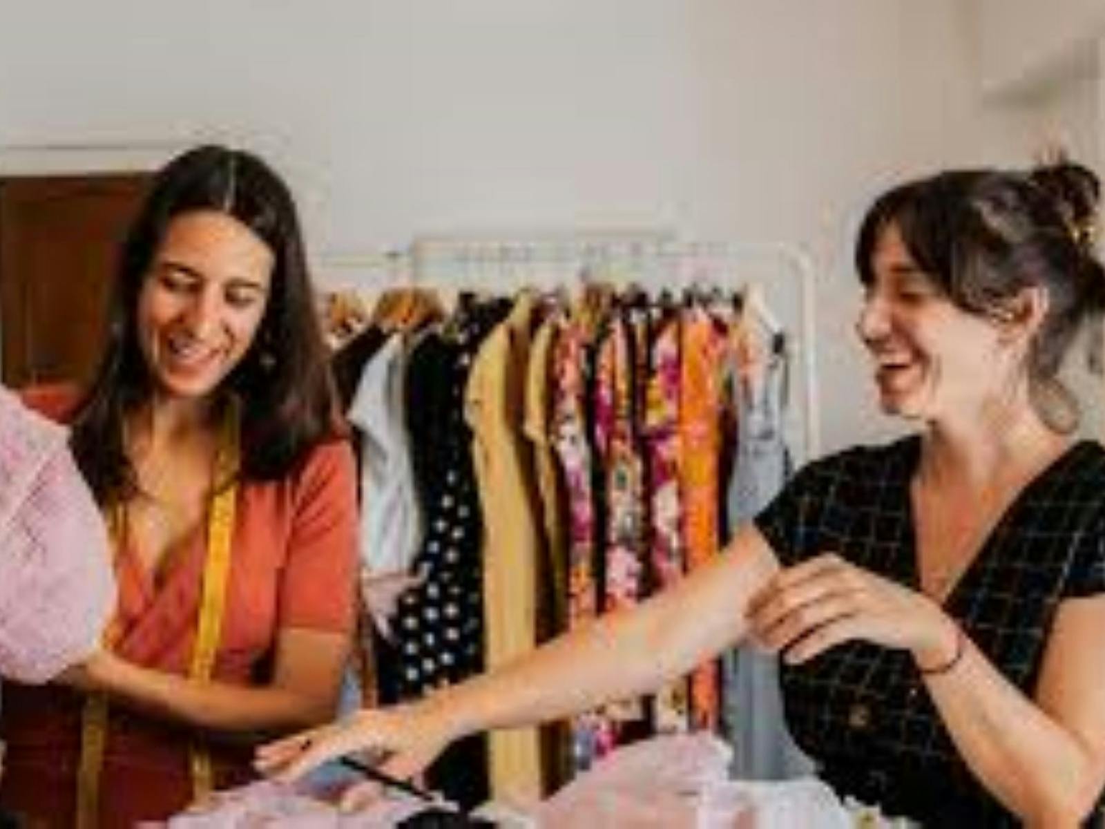 Two ladies laughing as they shop