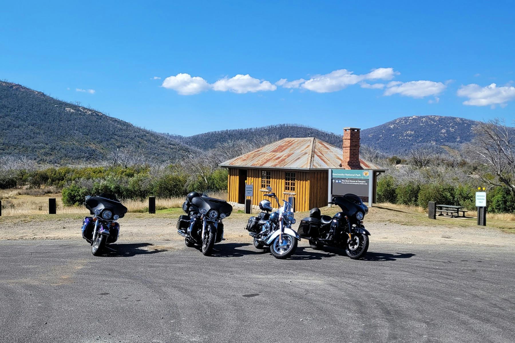 Motorcycles parked in front of historic hiking hut