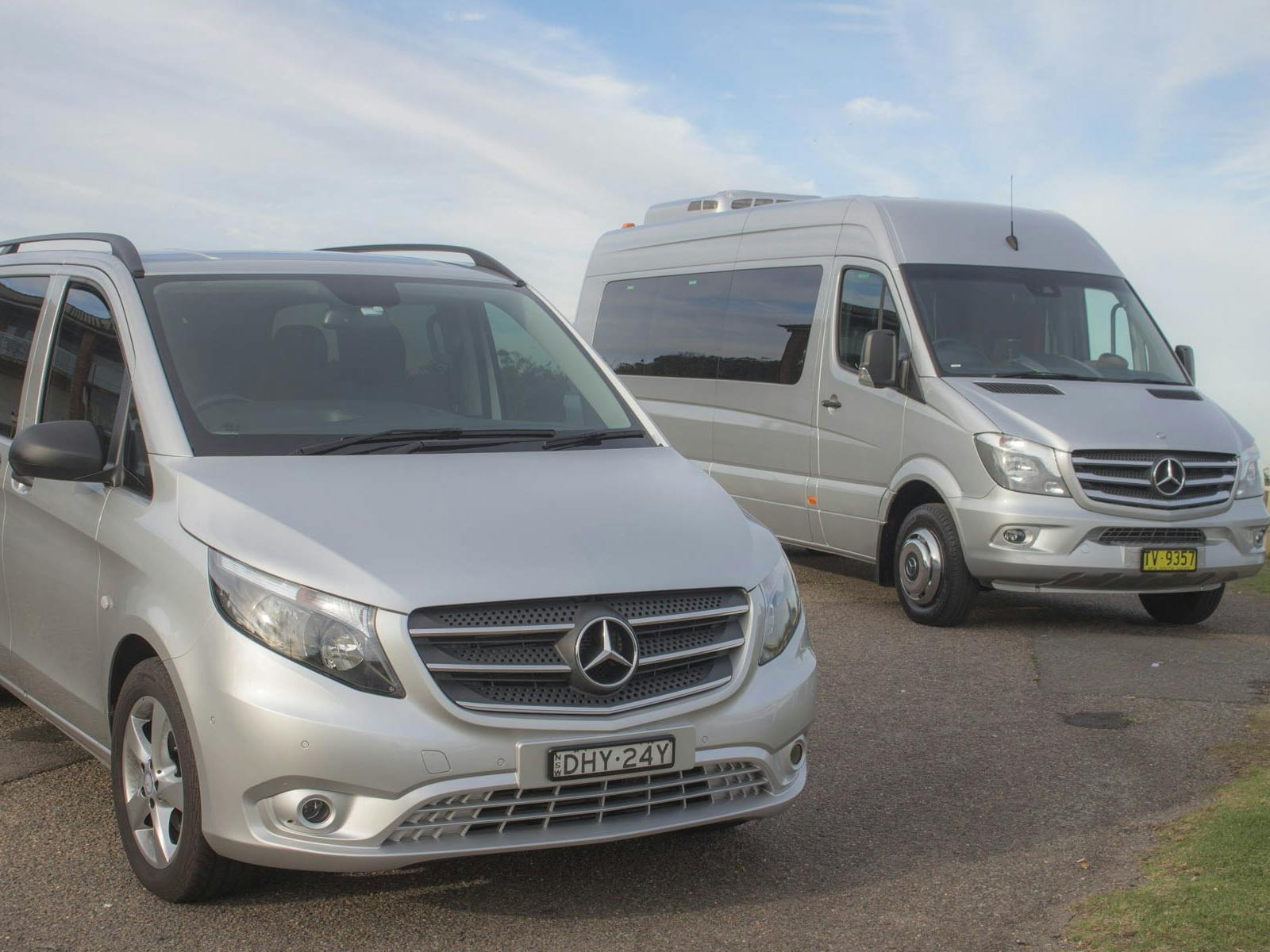 two silver Mercedes vans of different size. both Sydney Adventure Tours transport