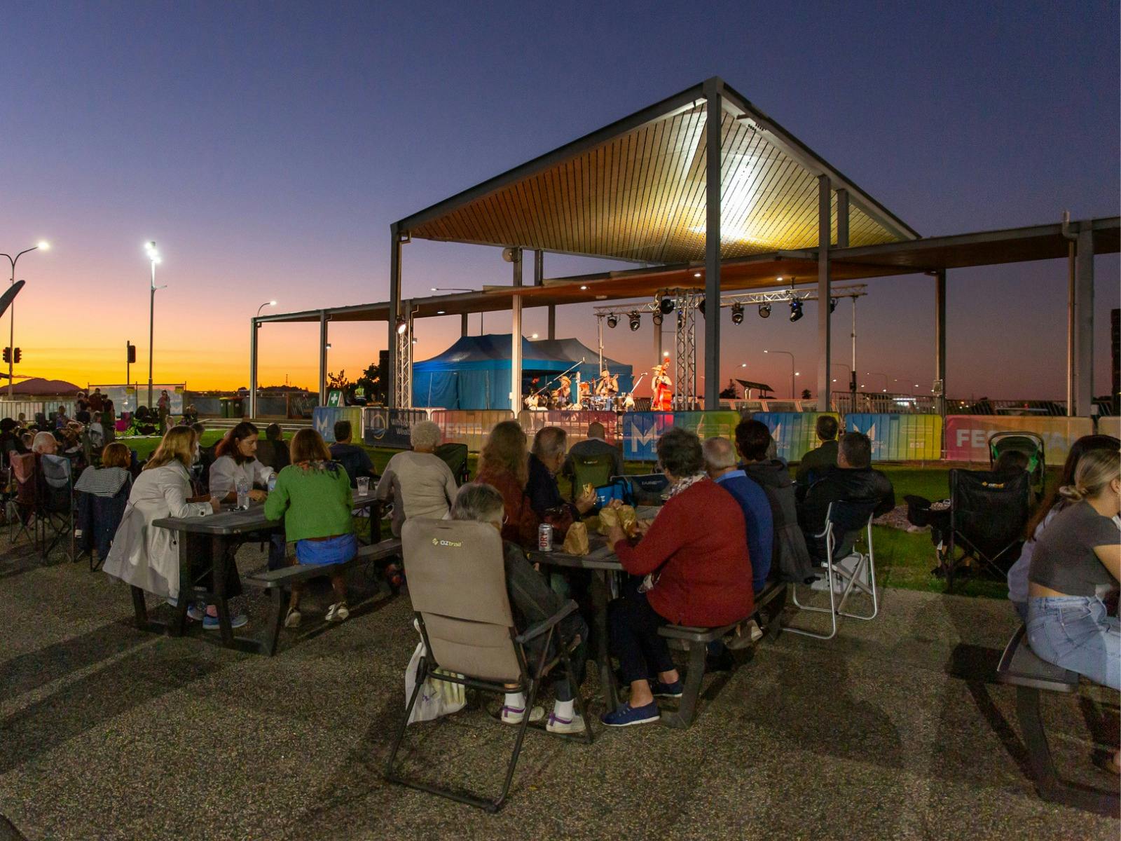 People gathered, sitting at an outdoor event People gathered, sitting at an outdoor event