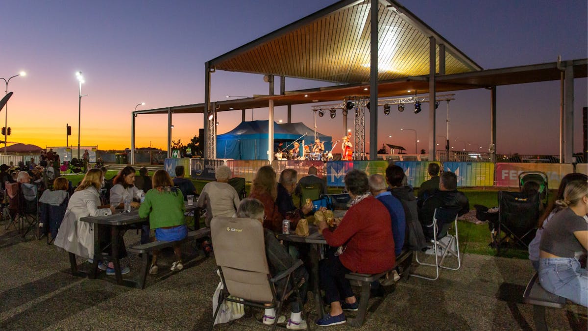 People gathered, sitting at an outdoor event