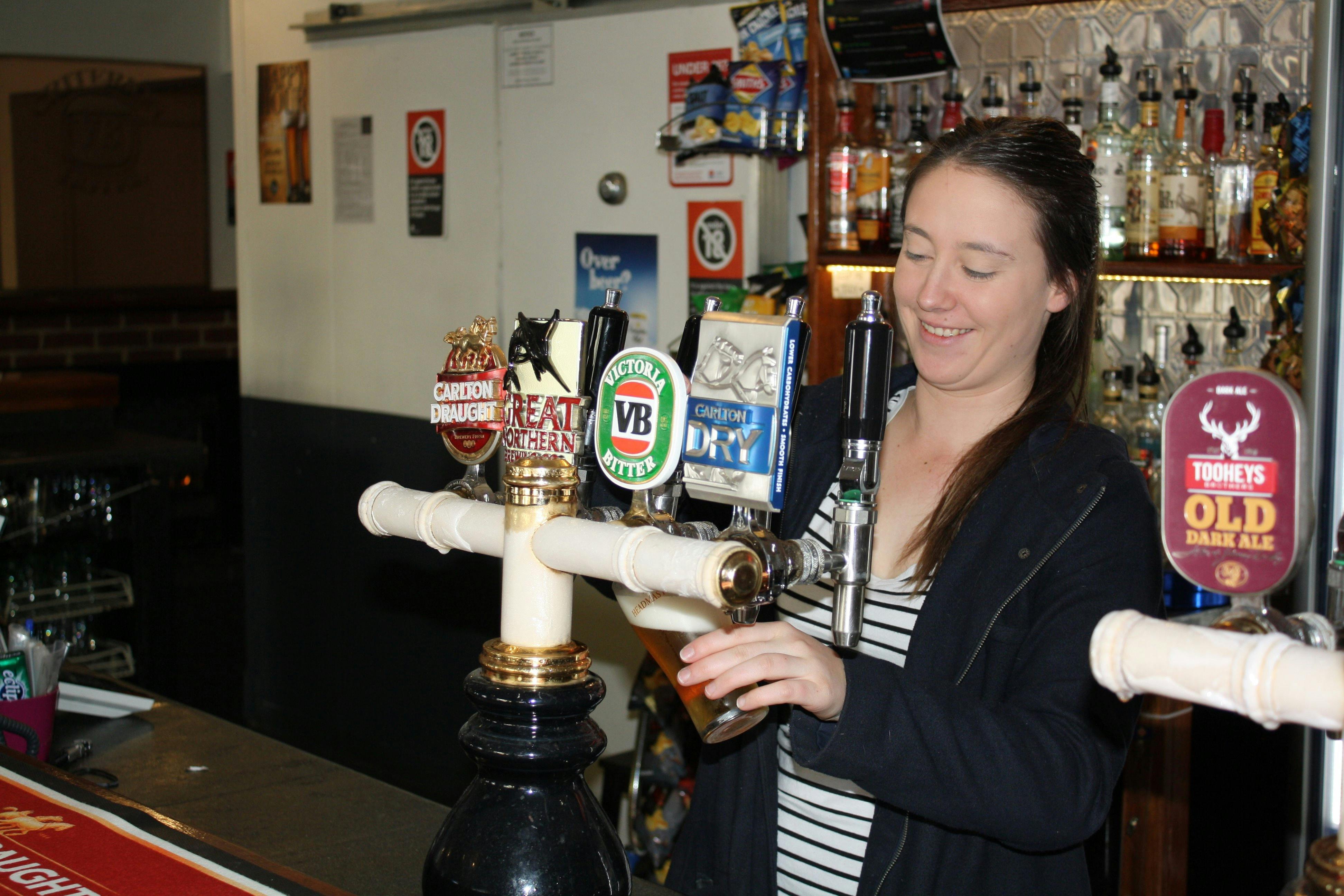 Girl pouring a beer at the bar