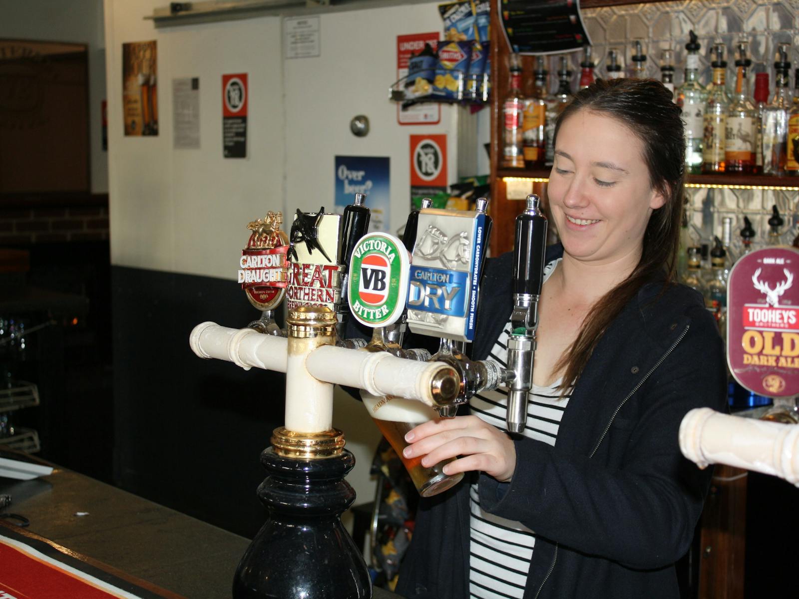 Girl pouring a beer at the bar