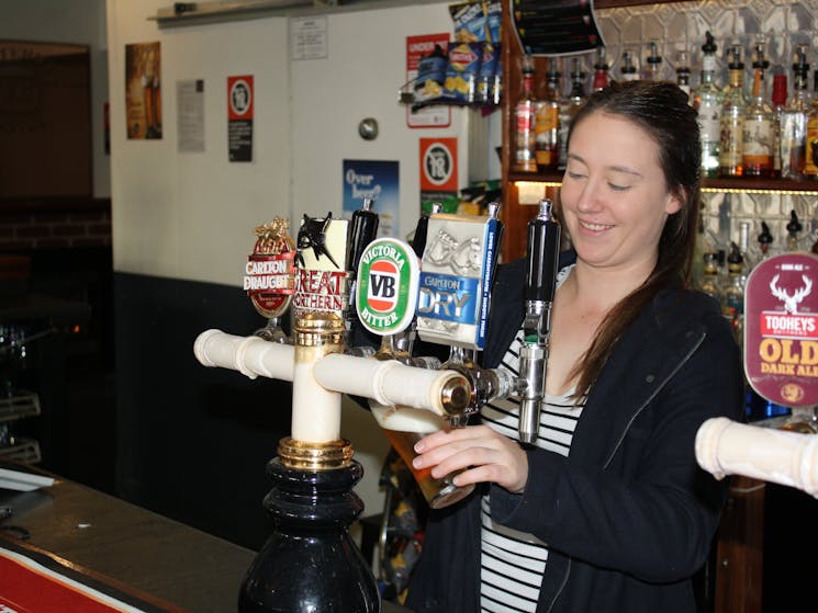 Girl pouring a beer at the bar