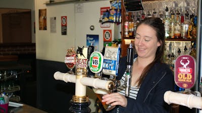 Girl pouring a beer at the bar