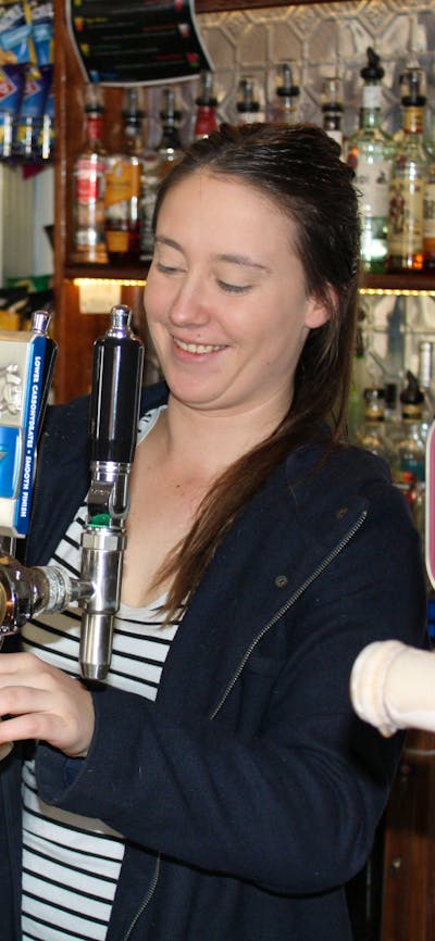 Girl pouring a beer at the bar