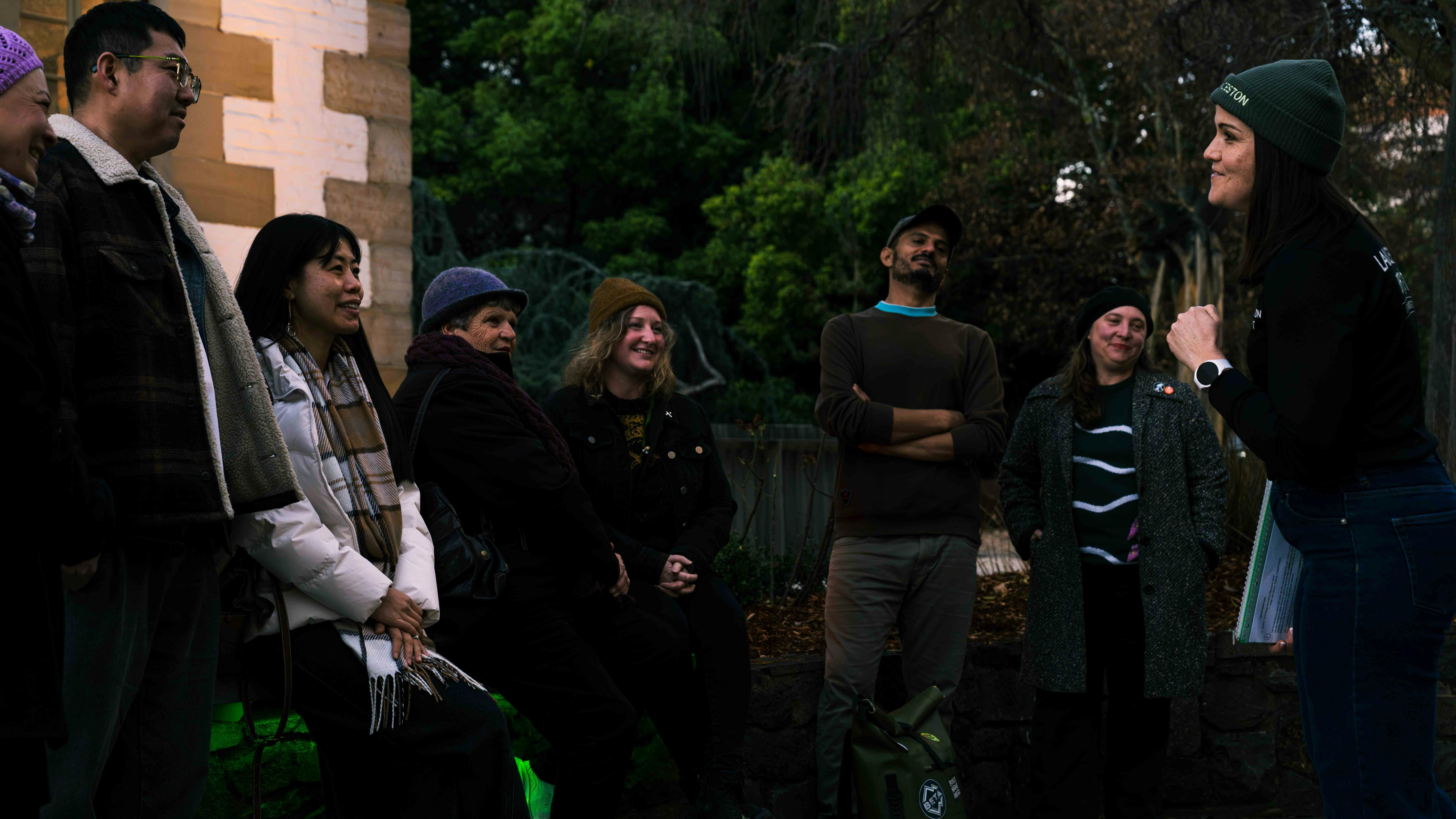 Guests listening to their Launceston By Foot guide during an evening Dark Side walking tour.