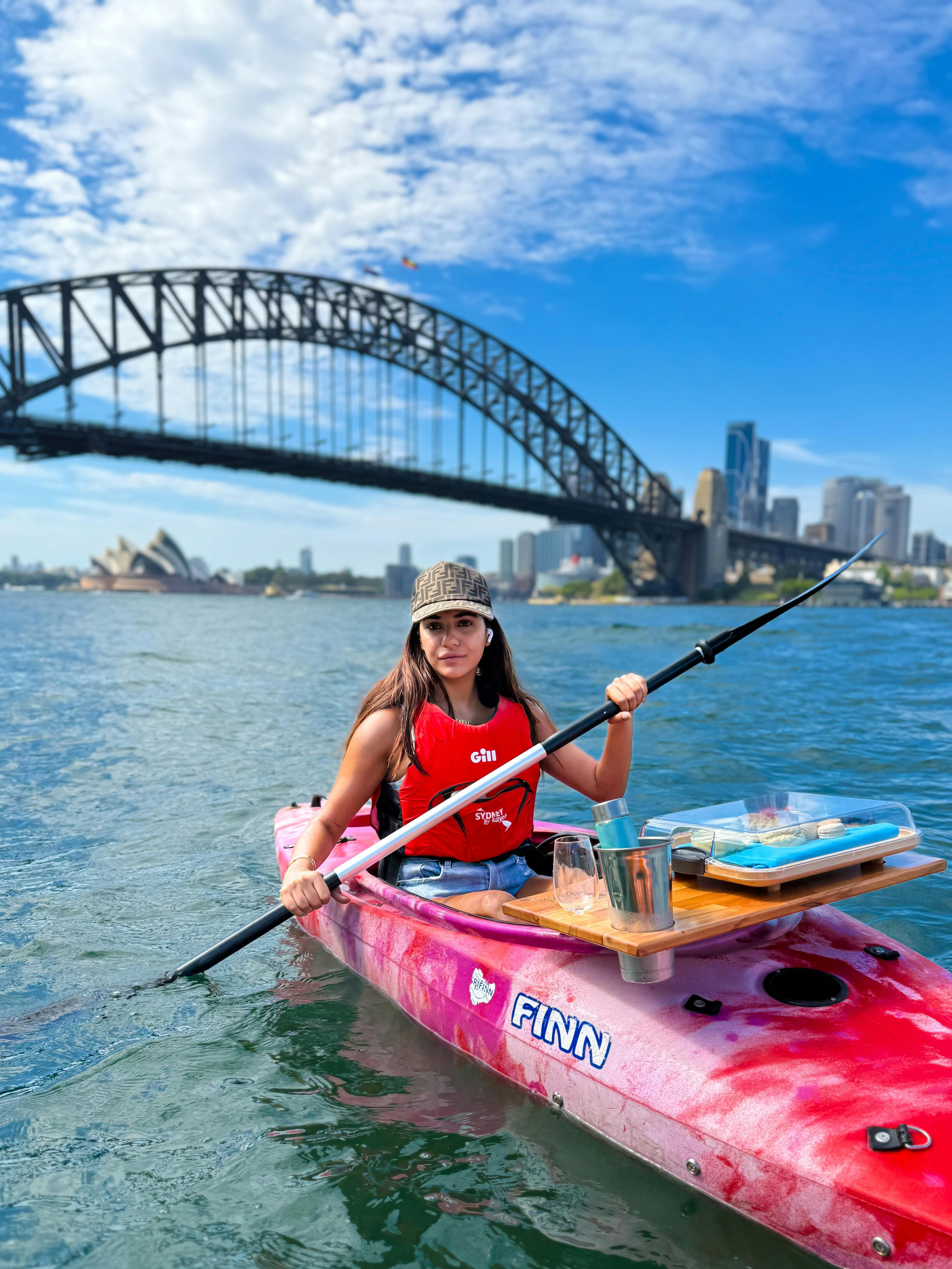 Lady paddling on Sydney Harbour with Sydney Harbour Bridge and Sydney Opera House in free photos