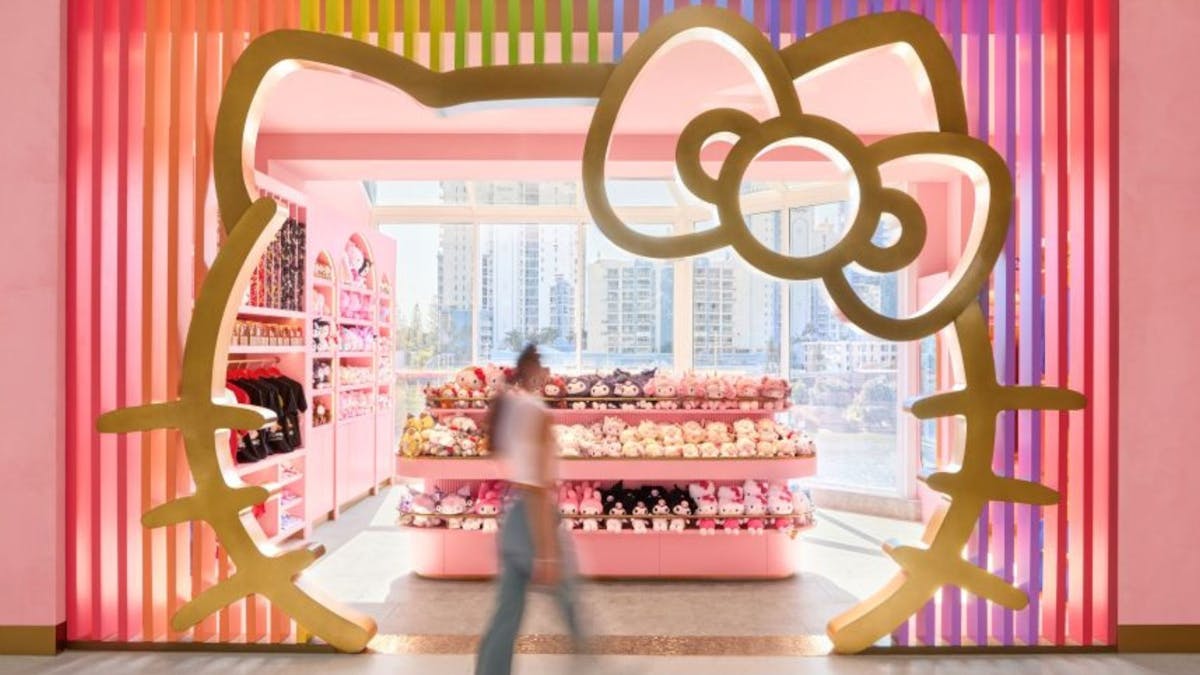 A retail entrance framed by a large Hello Kitty silhouette with pink interior.