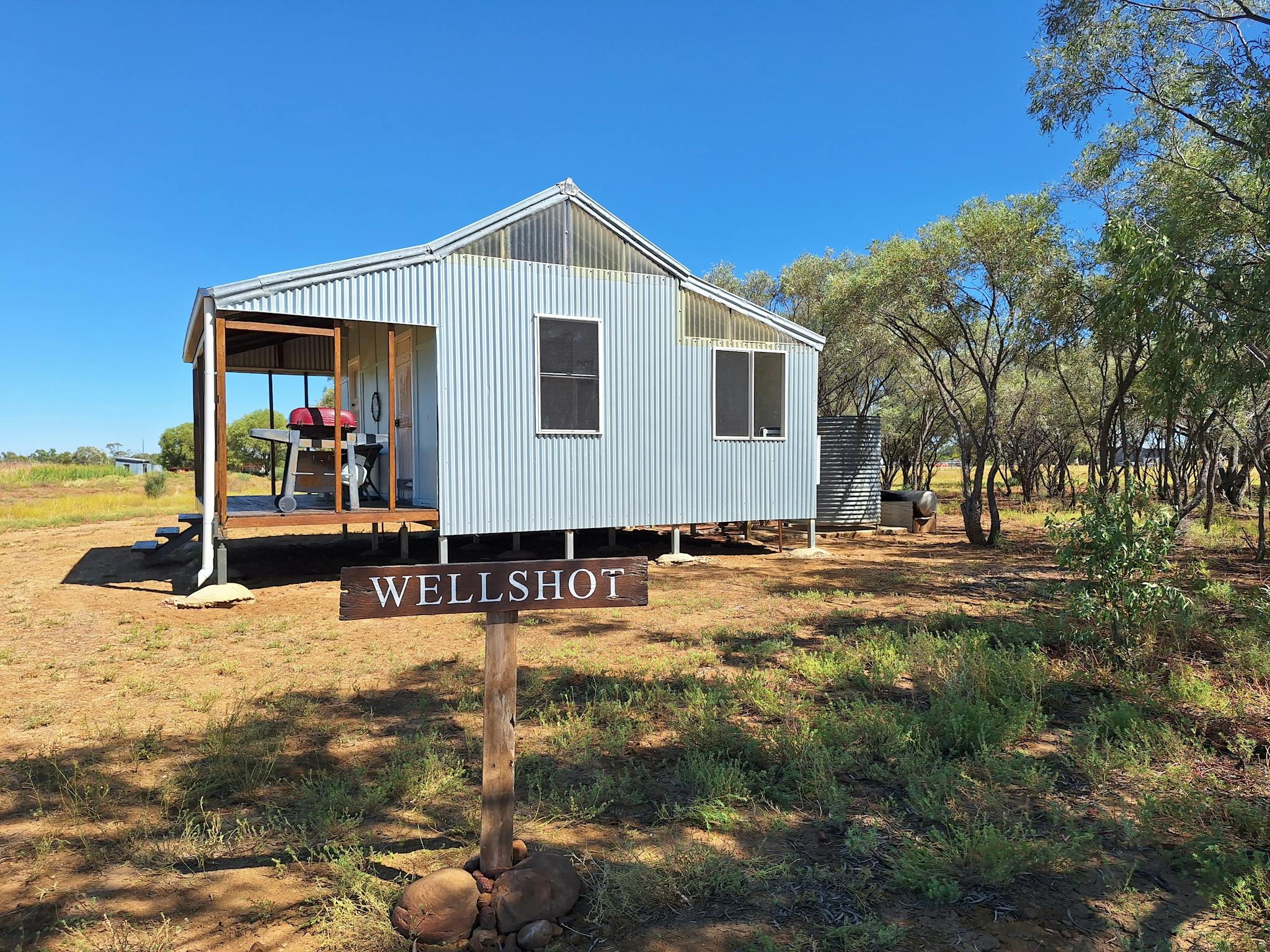 An iron cottage in an outback setting with a clear blue sky An iron cottage in an outback setting with a clear blue sky