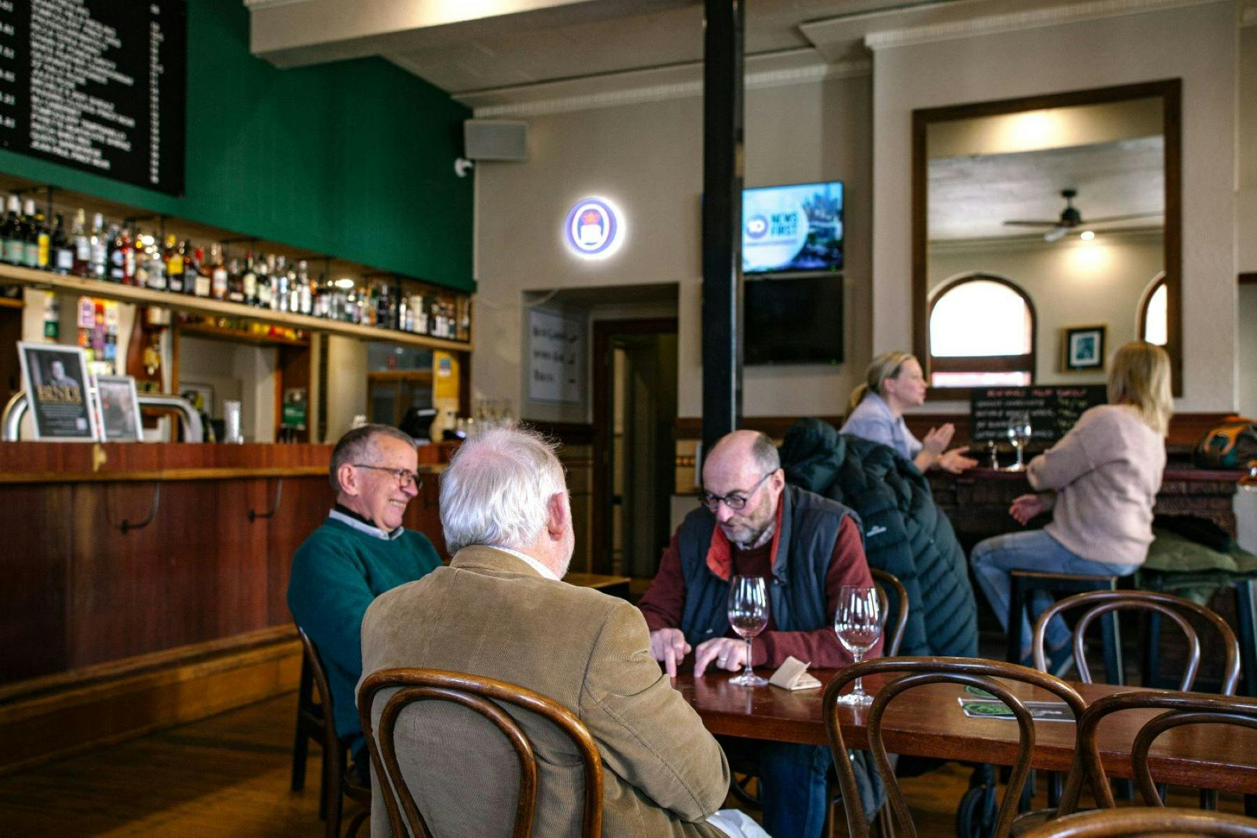 Men and women enjoying a casual drink in the public bar.