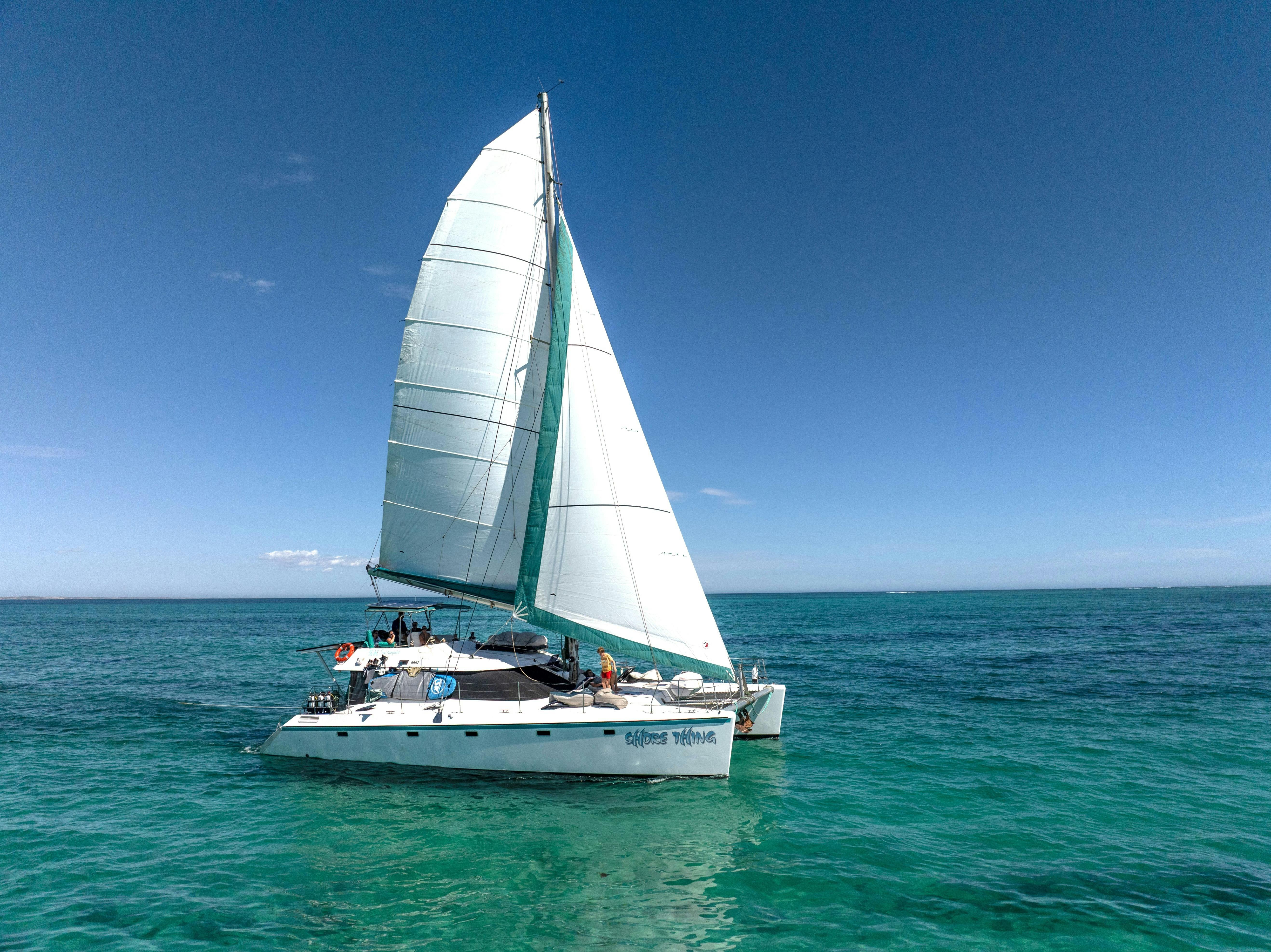 Sailing catamaran 'Shore Thing' with full sails up.