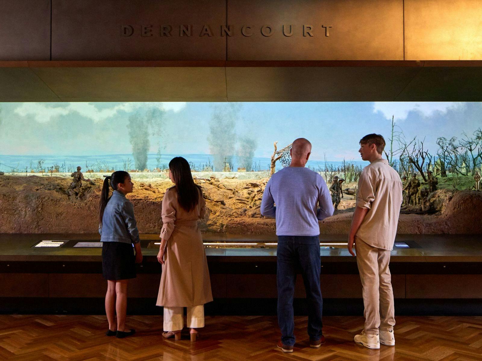 A group of people looking at the Dernancourt Diorama at the Australian War Memorial